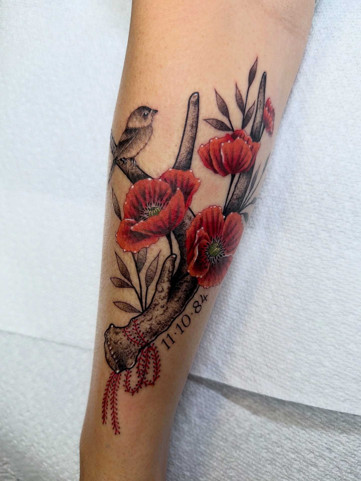 Poppy flowers and baseball bat realism tattoo on the forearm by Savannah Compton