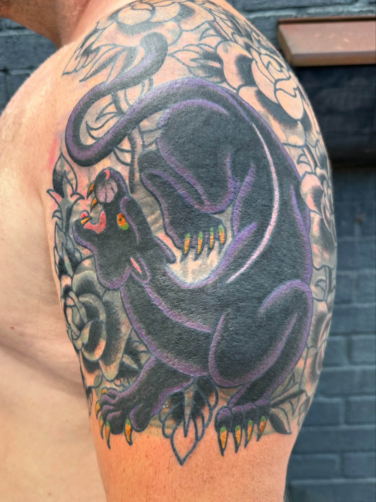 Demon American traditional tattoo on the upper arm by Chris Blanchard