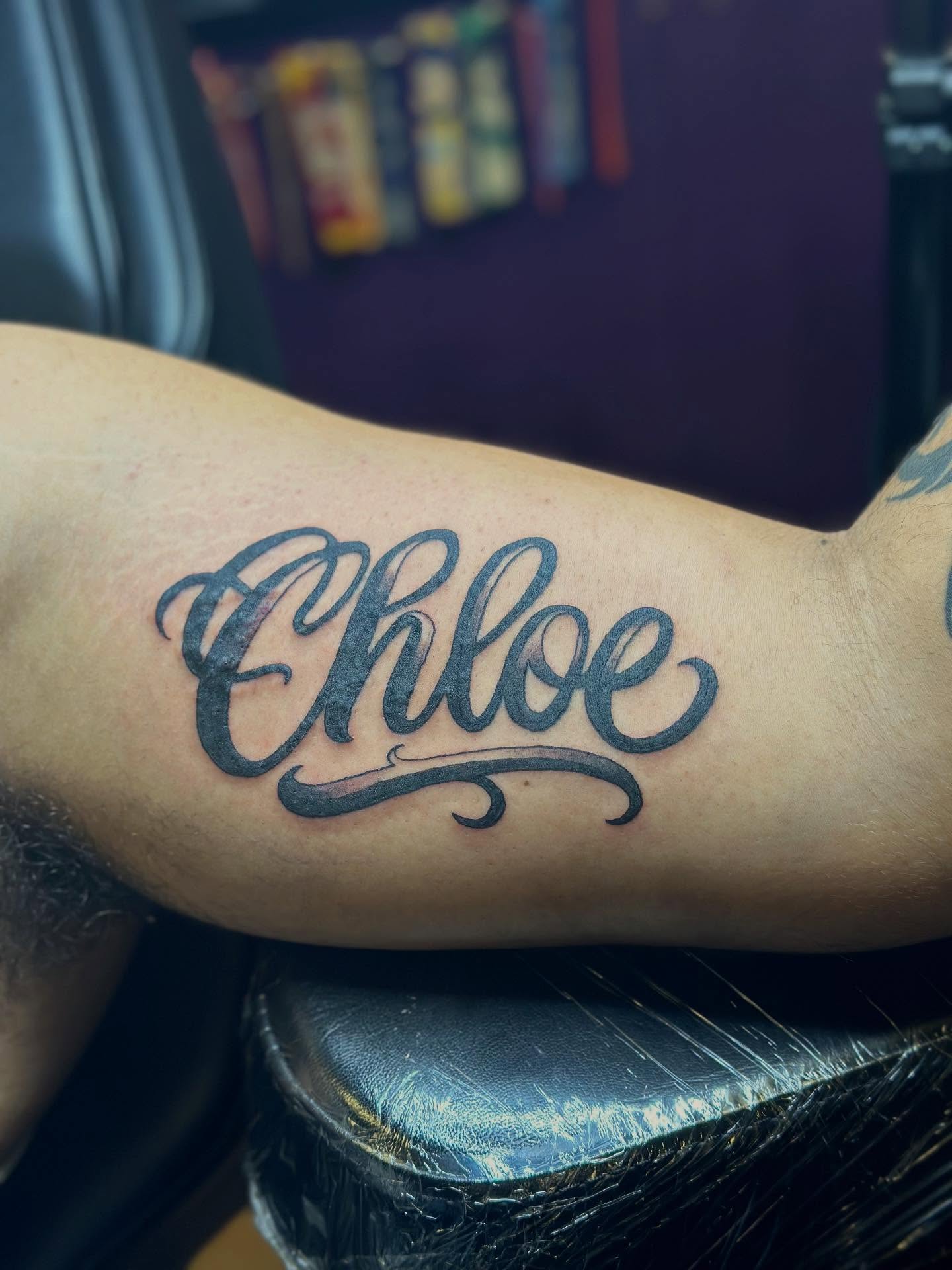 Chloe lettering script tattoo on the forearm by Joshua Ware, Alvarado, Texas