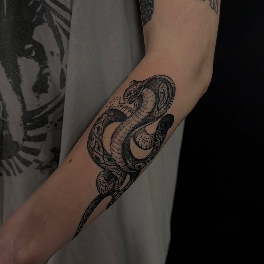 Cobra snake surrealism tattoo on the forearm by Dee, San Diego, California