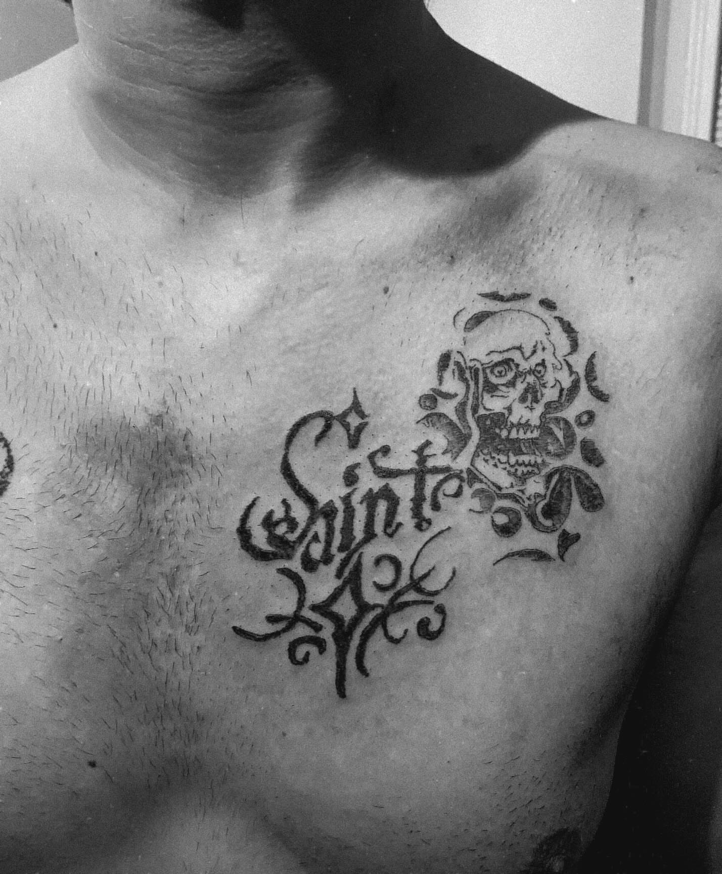 Saint black and grey tattoo on the chest by Swag Originator