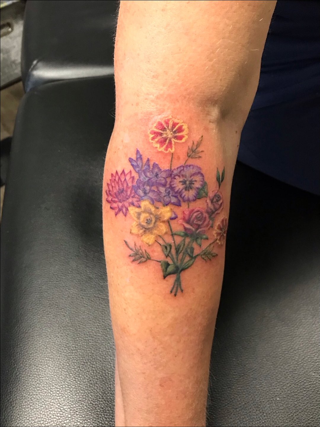 Floral bouquet realism tattoo on the forearm by Cortnie, Nashville, Tennessee