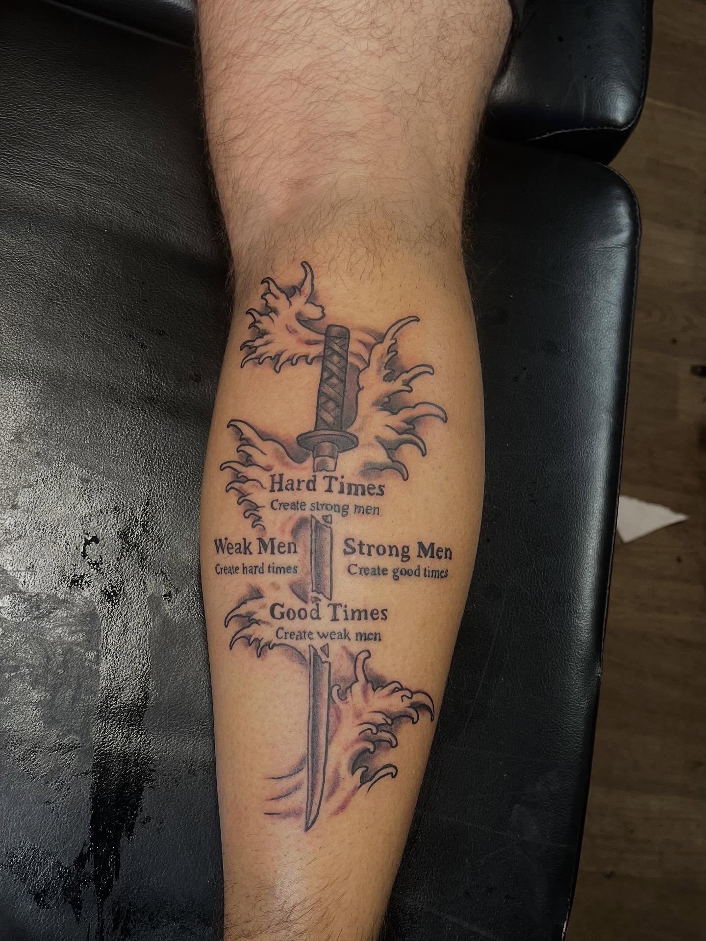 Sword and flame black and grey tattoo on the forearm by Rich