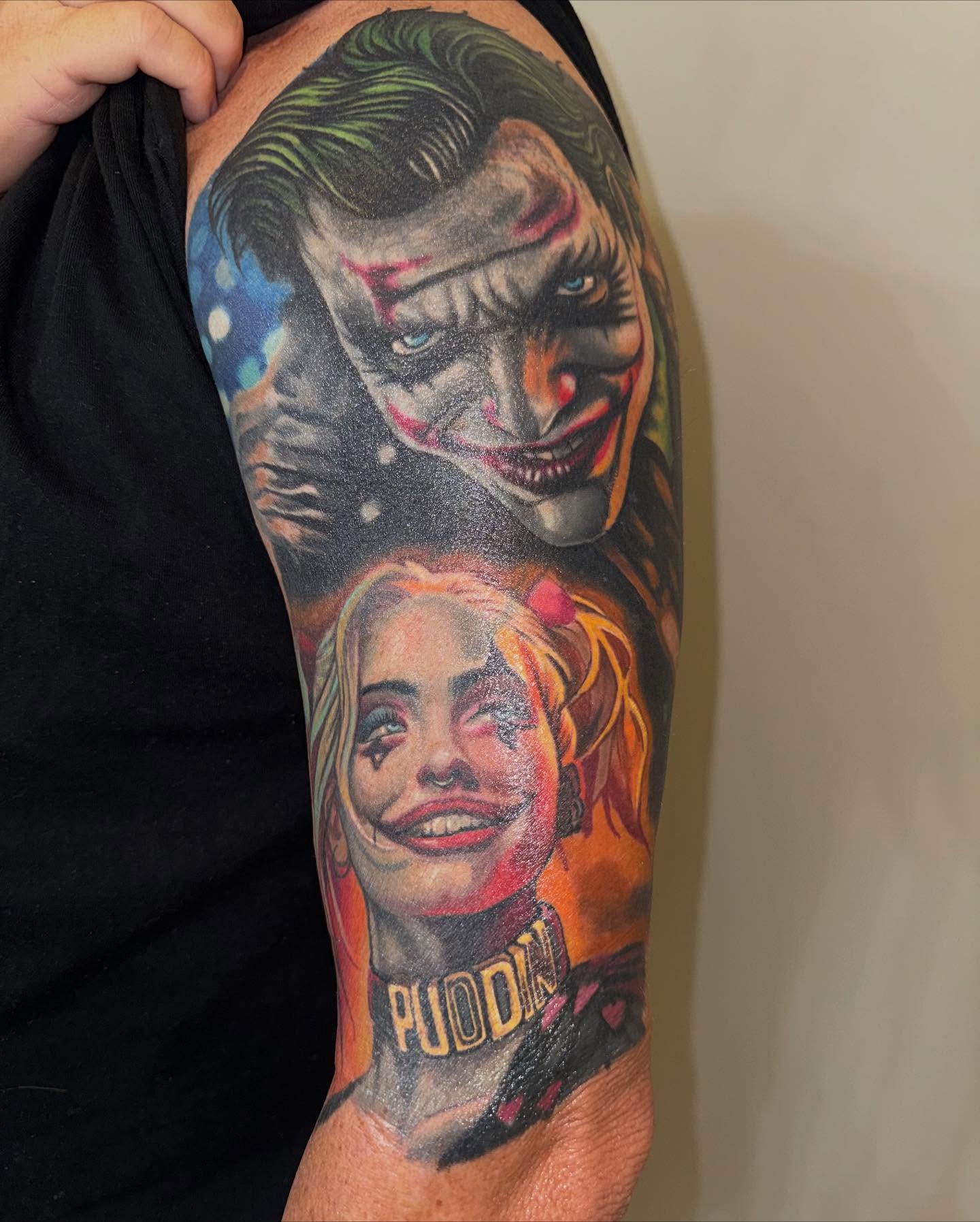 Joker and harley quinn realism tattoo on the forearm by Art Lopez