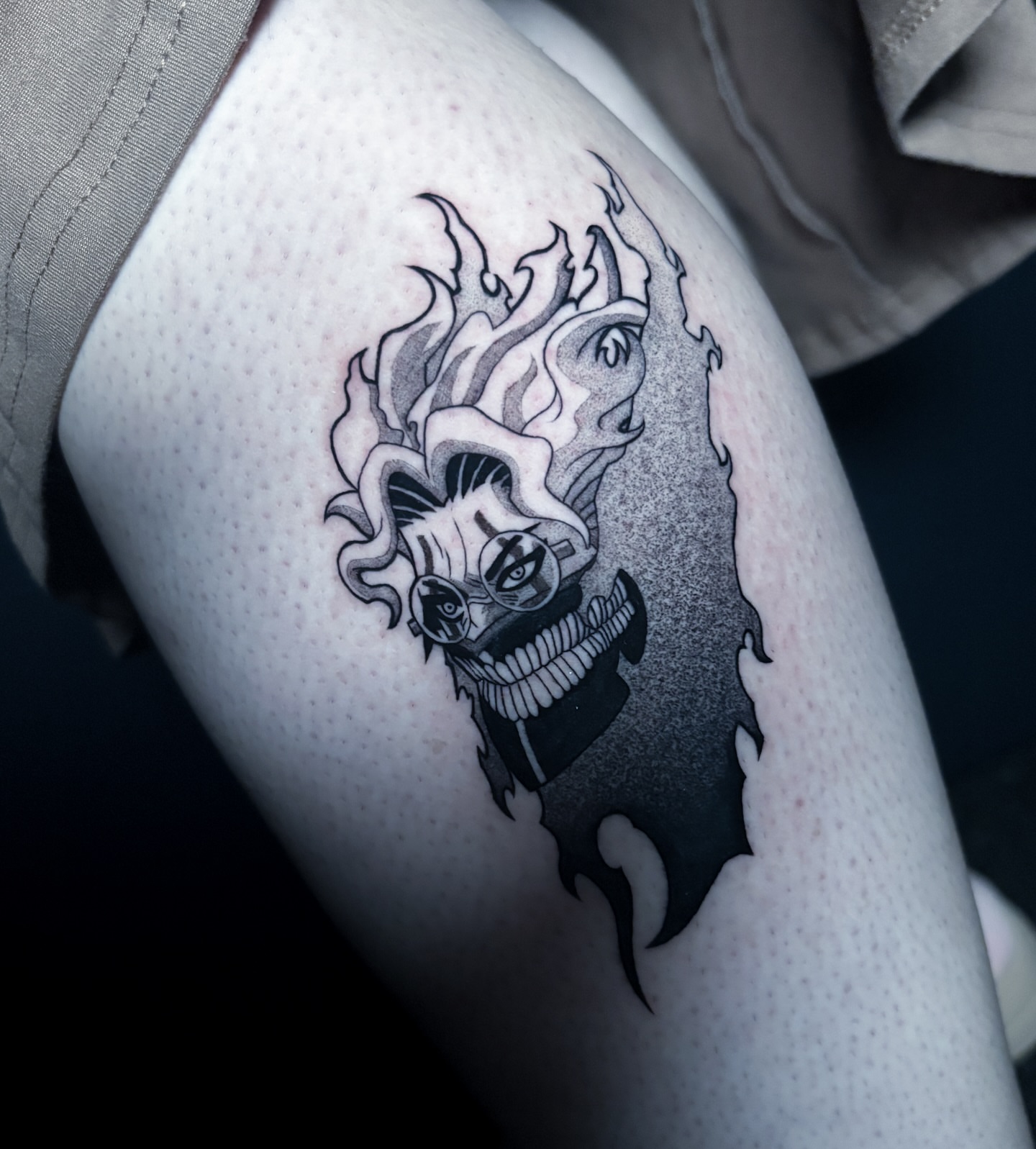 Joker black and grey tattoo on the thigh by Noah Dang Ink