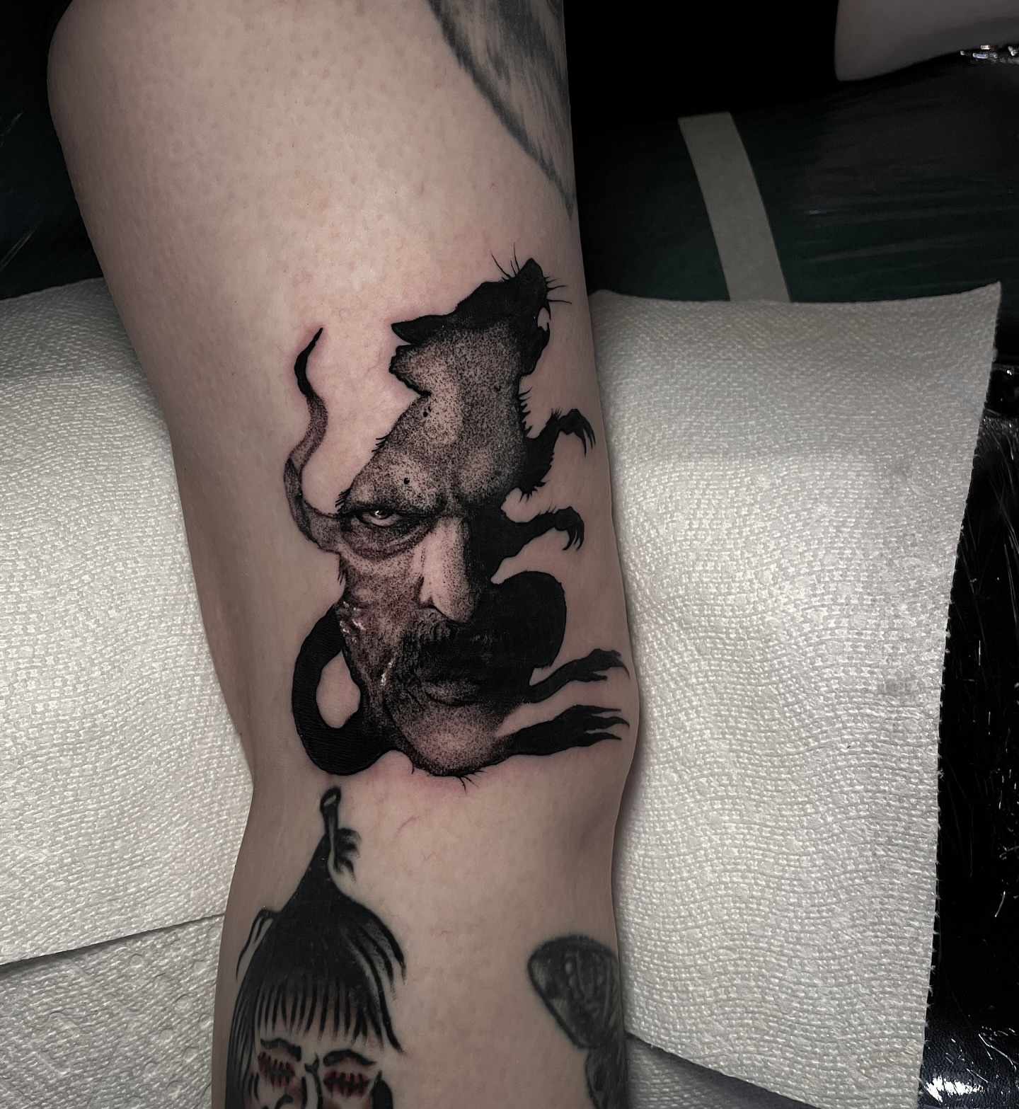Man's face realism tattoo on the forearm by Ian Spong