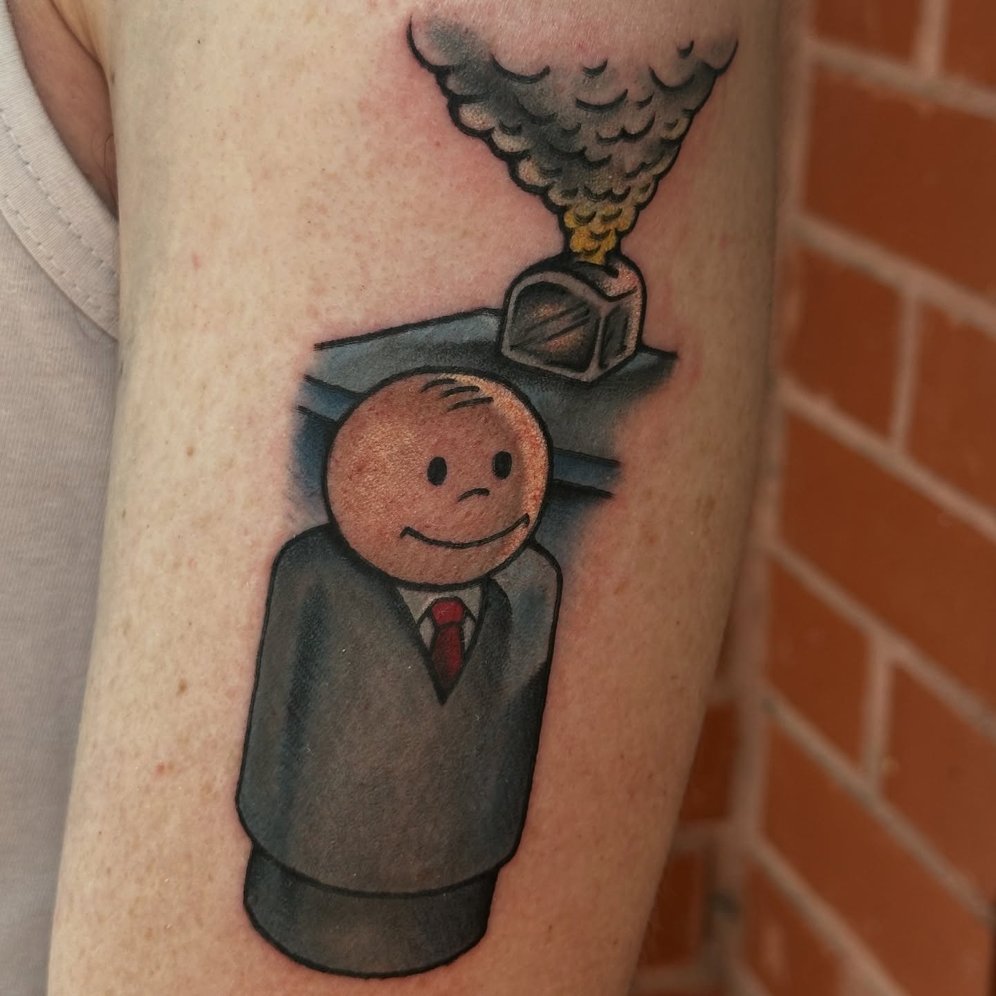 Man in suit American traditional tattoo on the forearm by kira