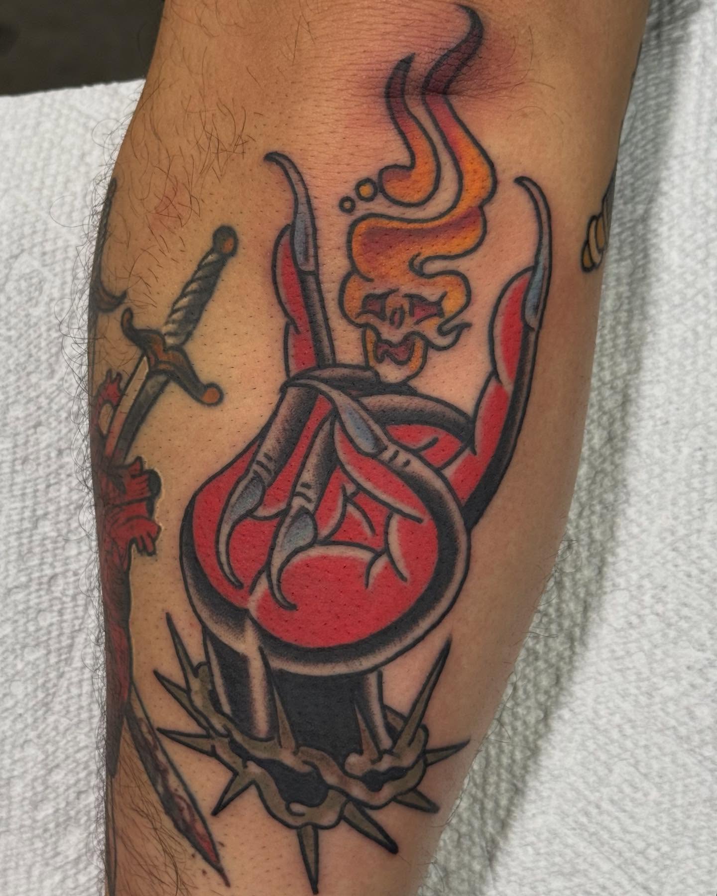 Heart with swords American traditional tattoo on the forearm by David Gottschalk