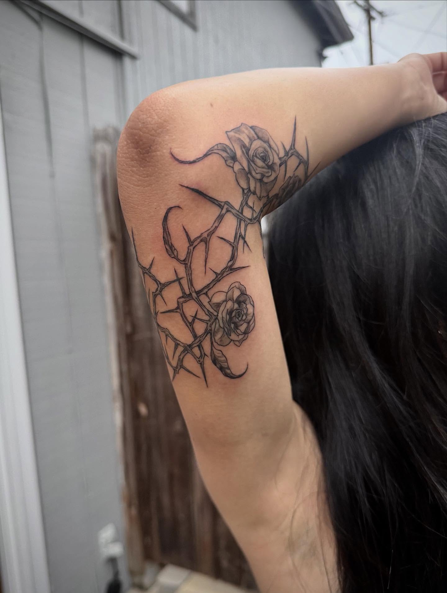 Roses and thorns realism tattoo on the forearm by Quin Walker