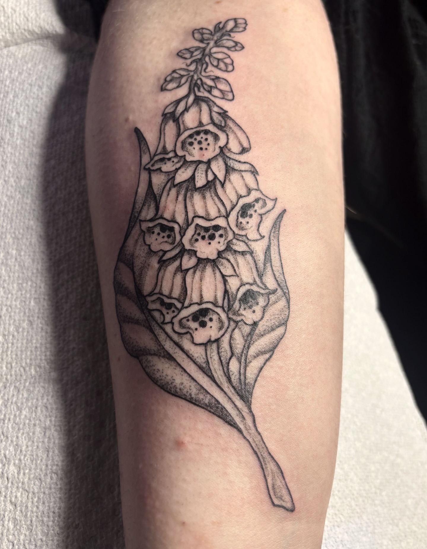 Foxglove flowers dotwork tattoo on the forearm by Nashville Tattoo Artist
