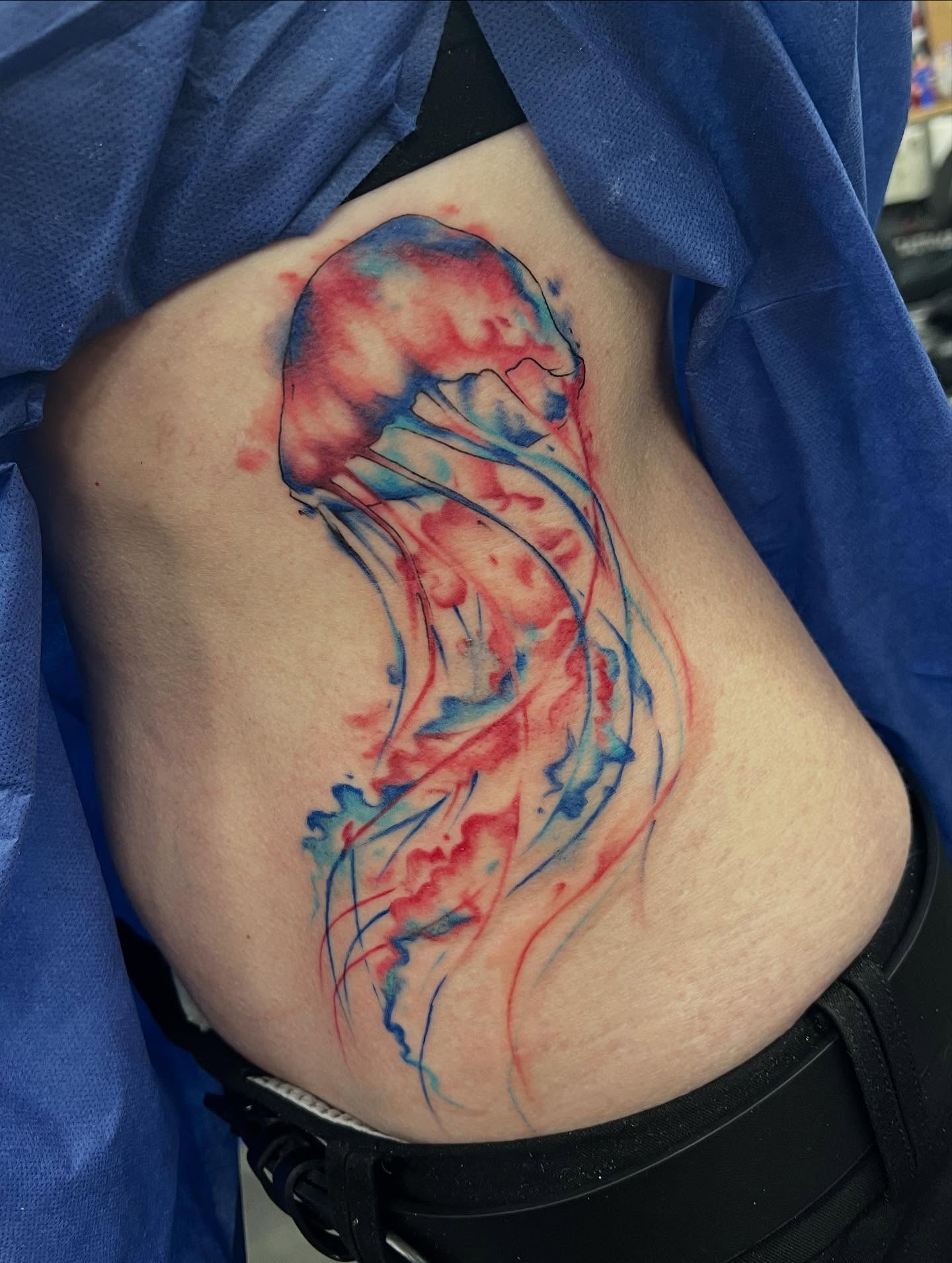 Jellyfish watercolor tattoo on the torso by l y n d s e y r i c k e t t s