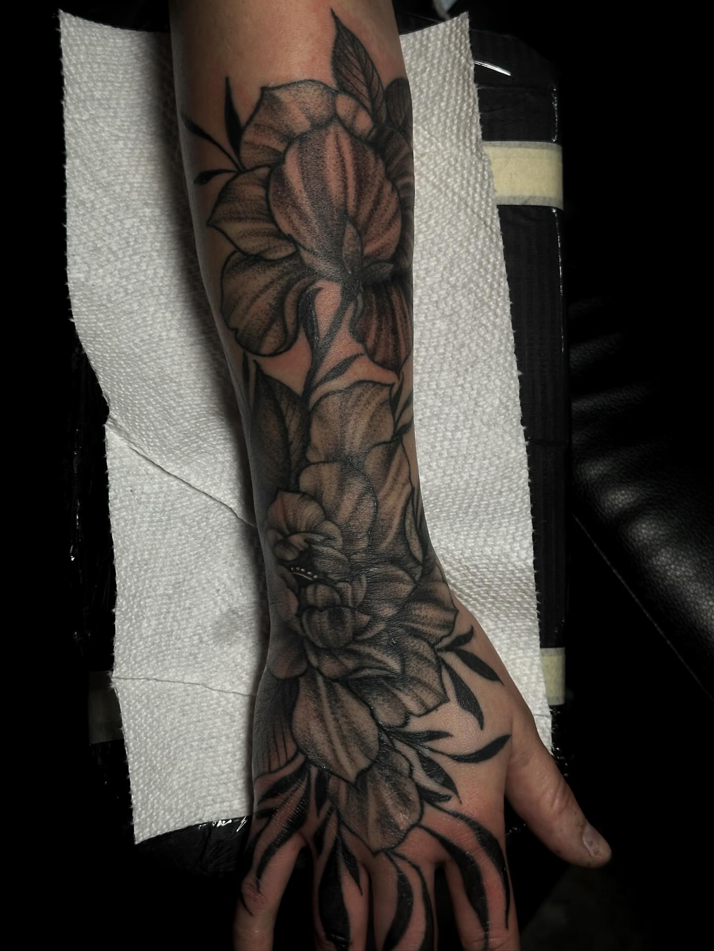 Floral bouquet black and grey tattoo on the forearm by Elizabeth Tabler