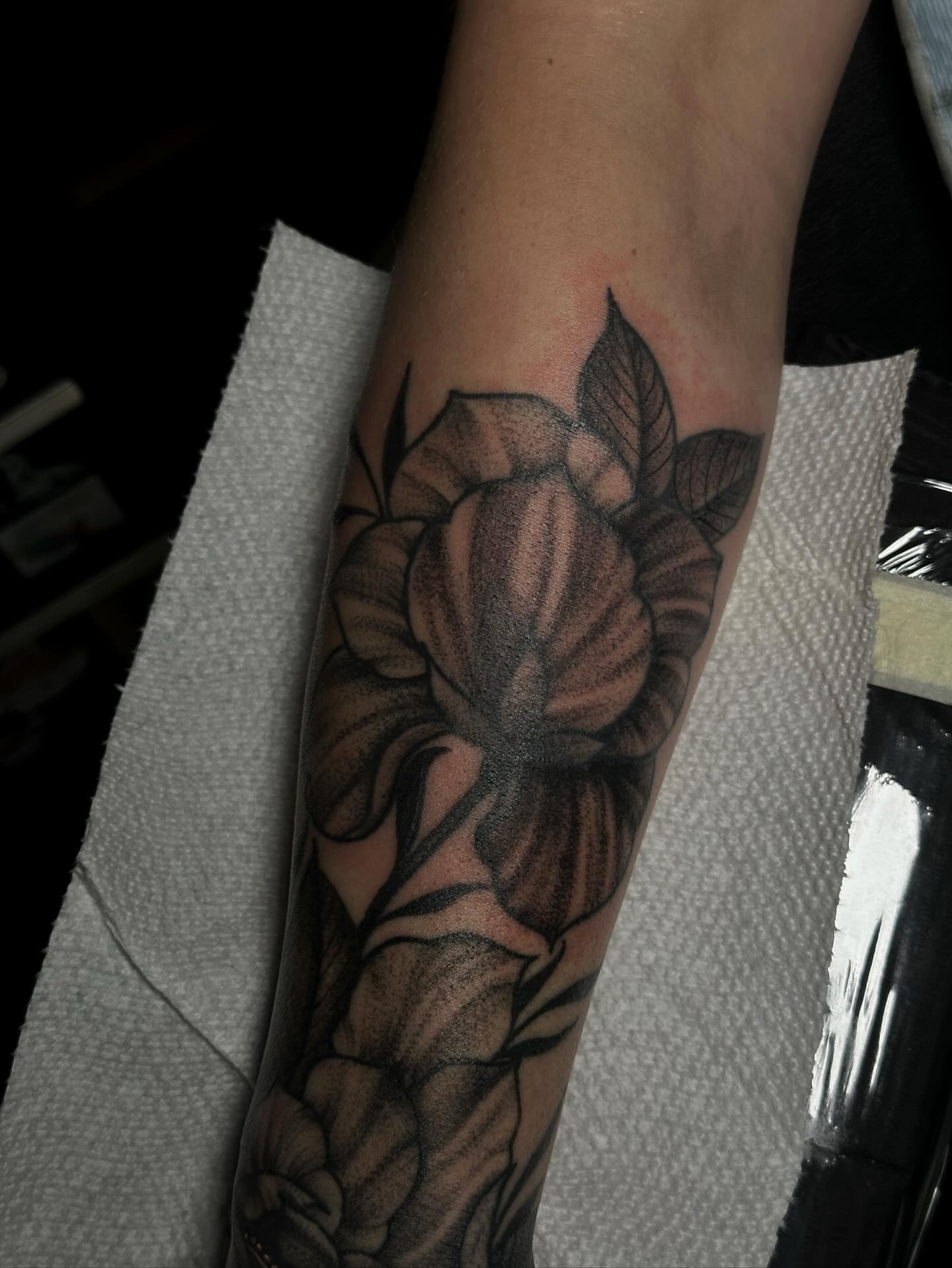 Flower black and grey tattoo on the forearm by Elizabeth Tabler