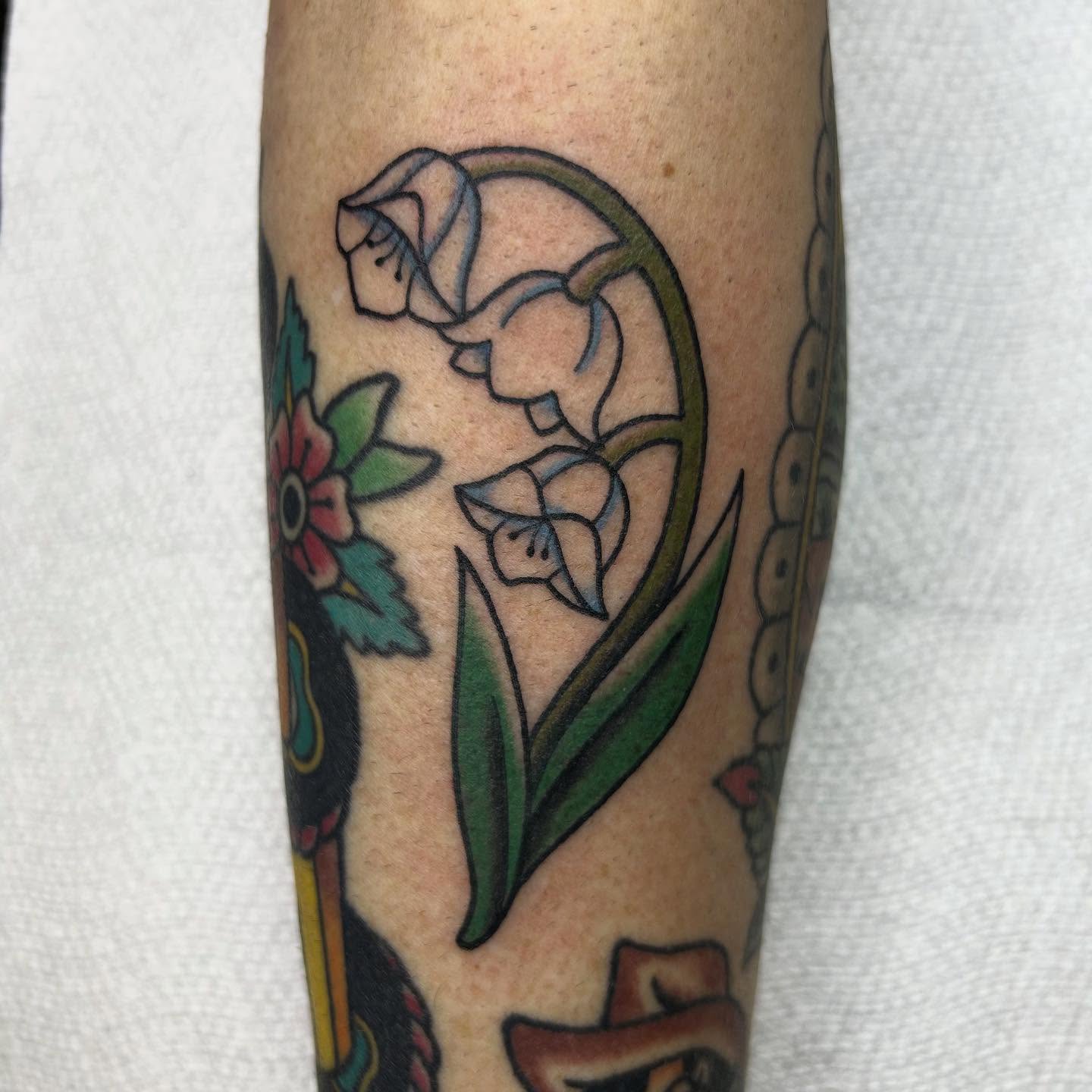 Lily of the valley American traditional tattoo on the forearm by Bregan ✨
