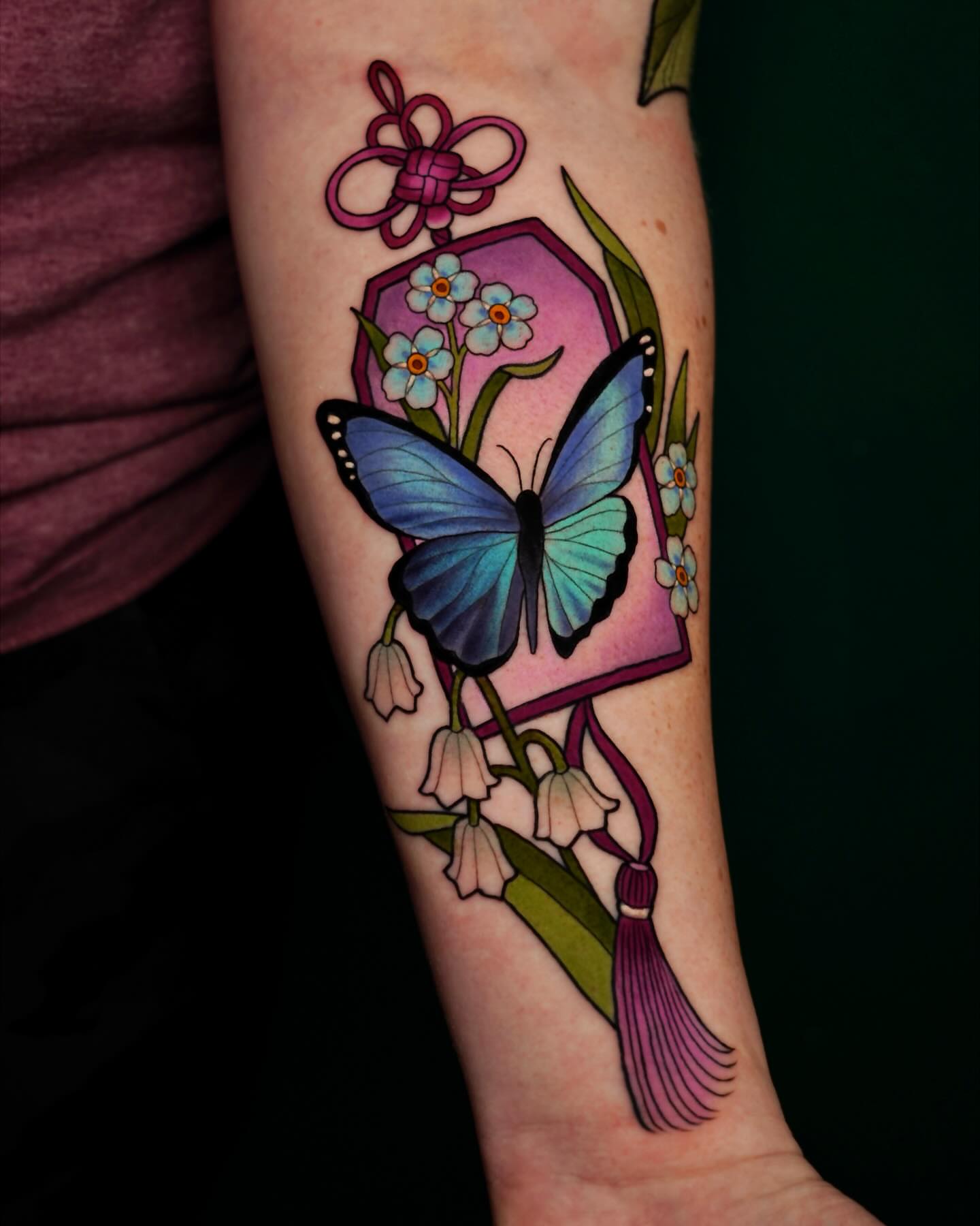 Butterfly and flowers new school tattoo on the forearm by Brooke Borden