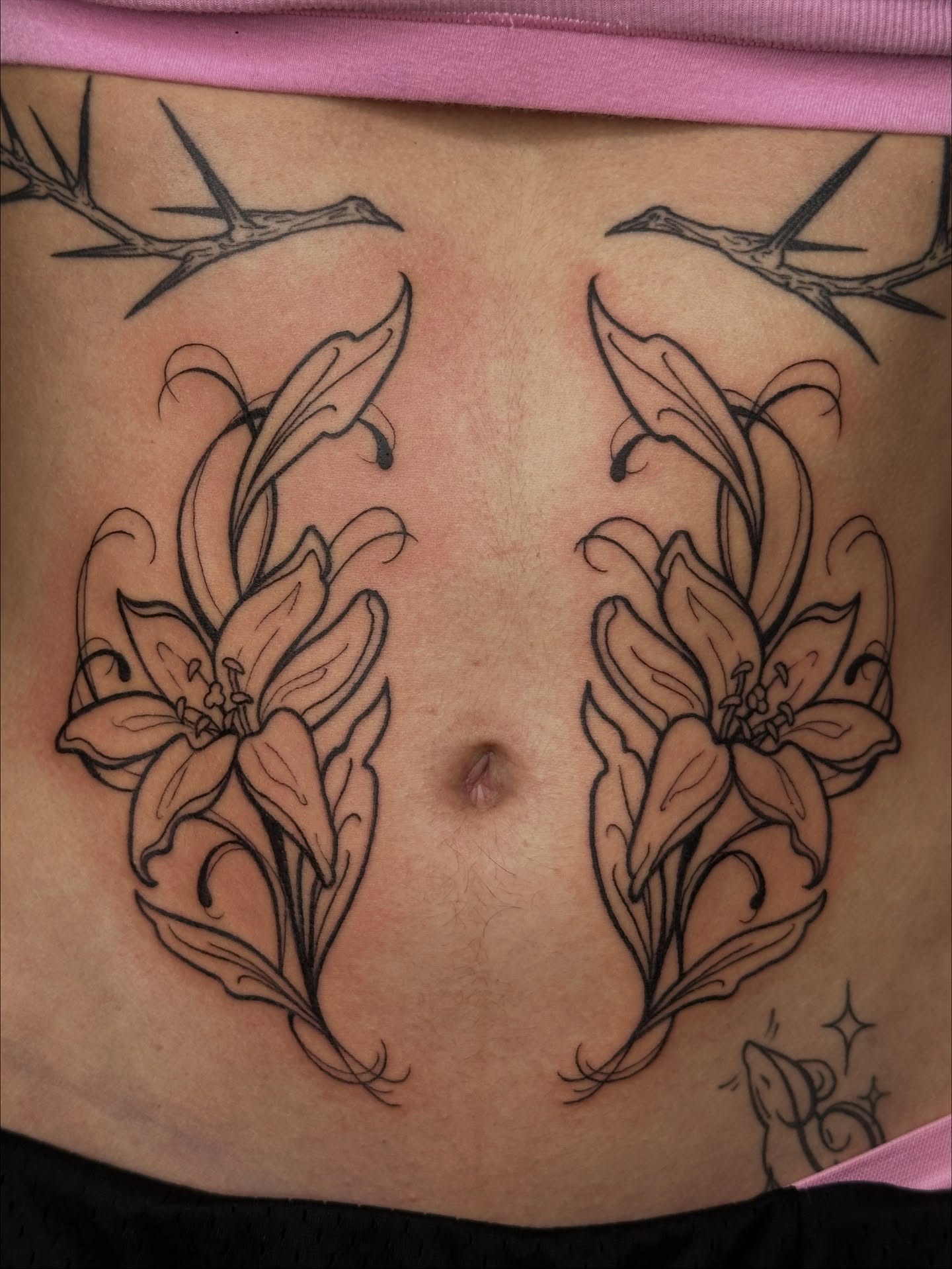 Lilies black and grey tattoo on the torso by Summer Shield