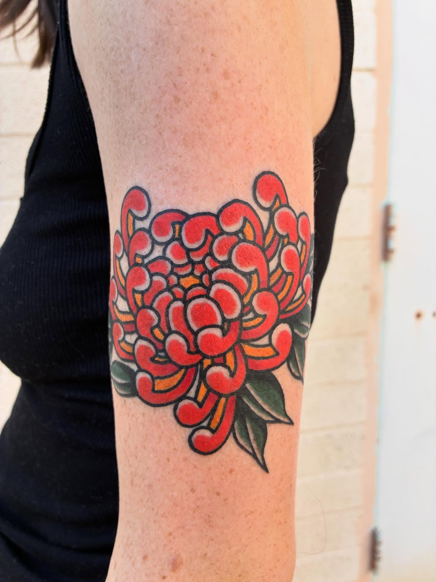Chrysanthemum American traditional tattoo on the forearm by Chrissie