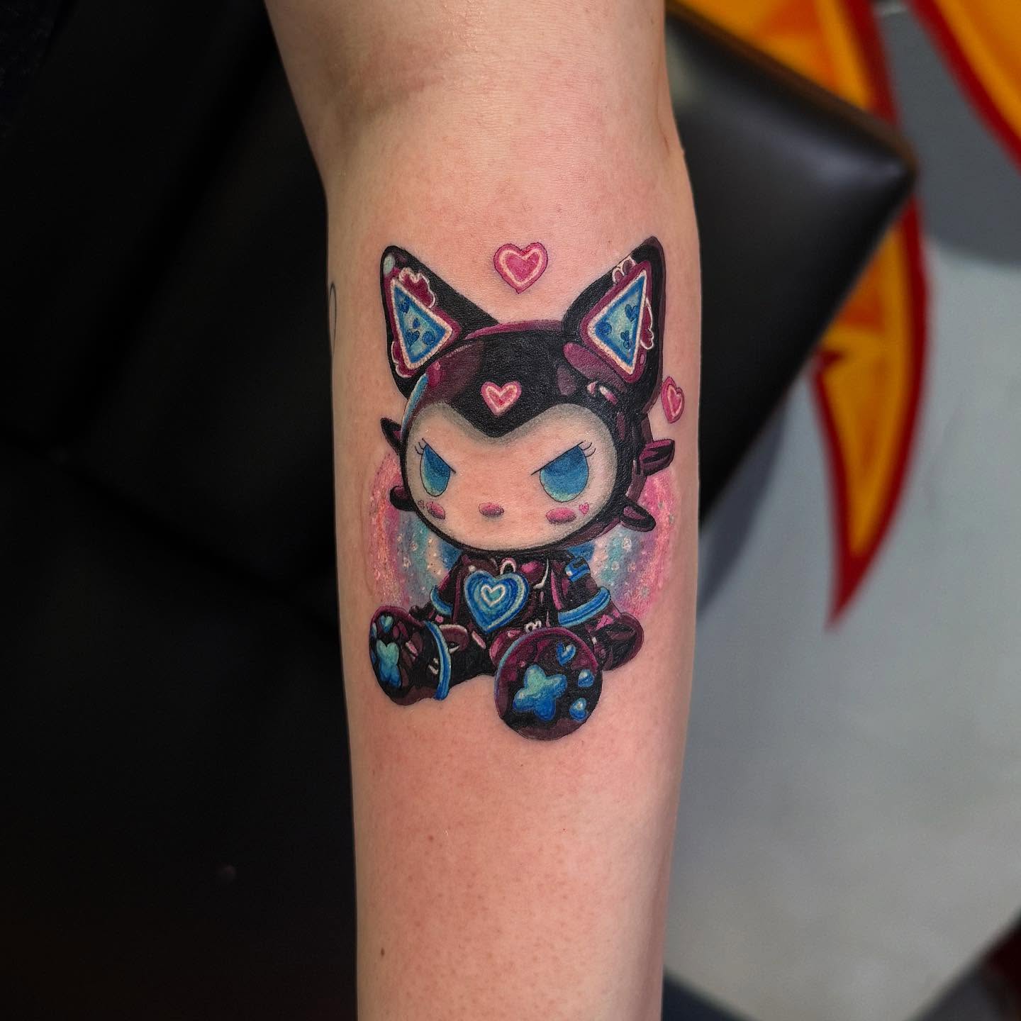 Chibi cat watercolor tattoo on the forearm by Manny