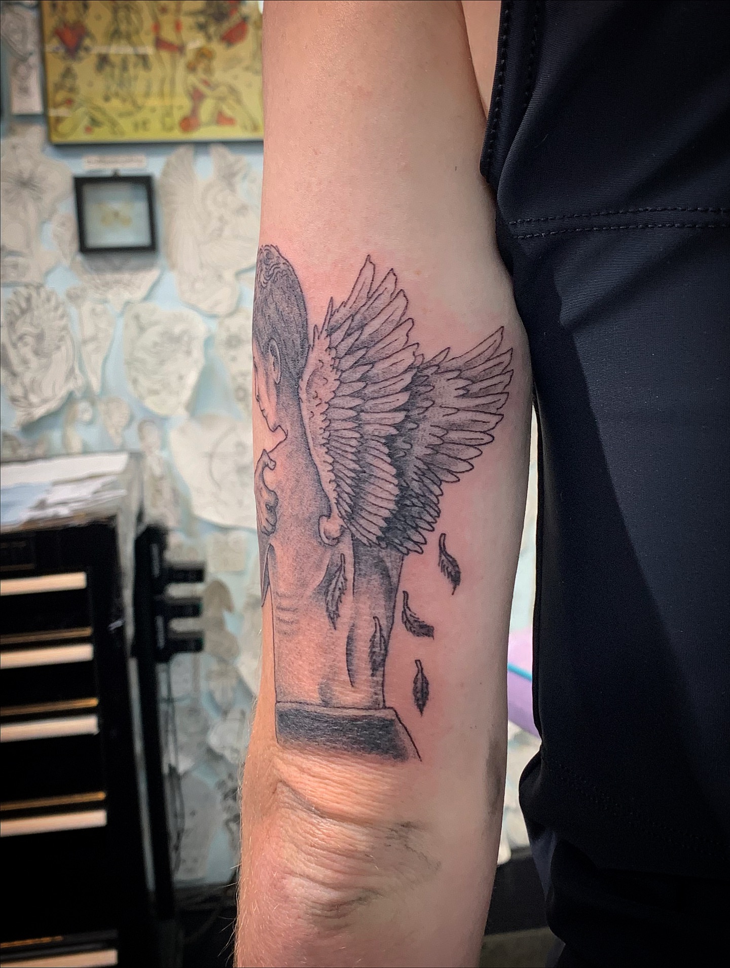 Angel with falling leaves realism tattoo on the forearm by Laura