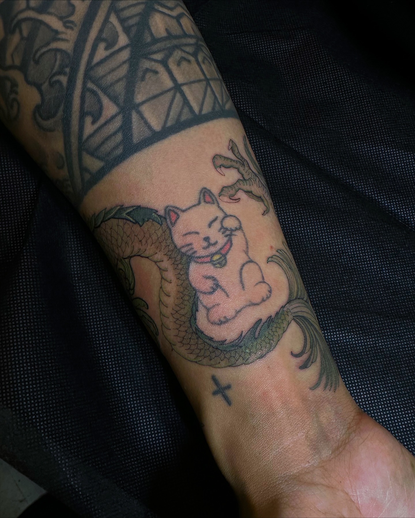 Cat and dragon American traditional tattoo on the forearm by Flower Tattoo Sf