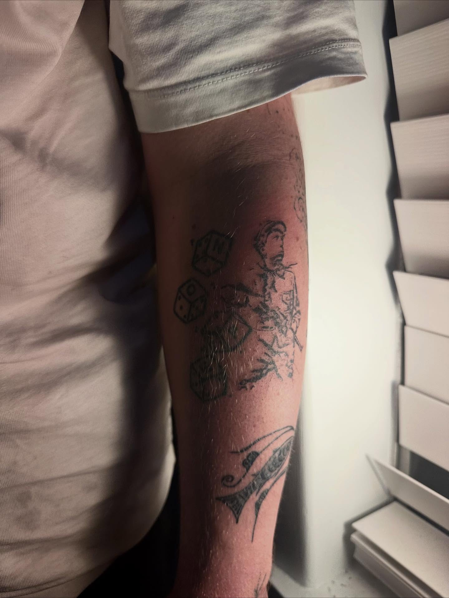 Dice and warrior black and grey tattoo on the forearm by Swag Originator
