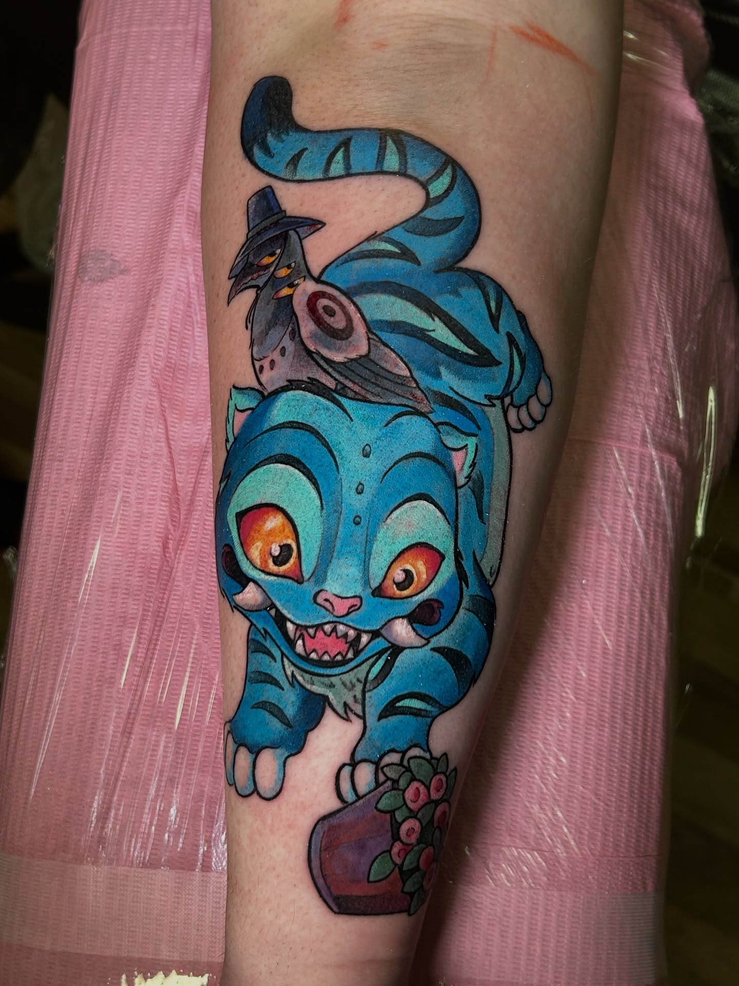 Blue cat with bird American traditional tattoo on the forearm by Mando Castro