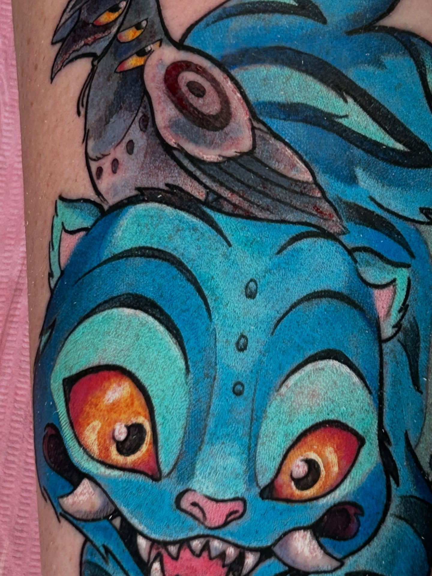 Blue cat American traditional tattoo on the forearm by Mando Castro