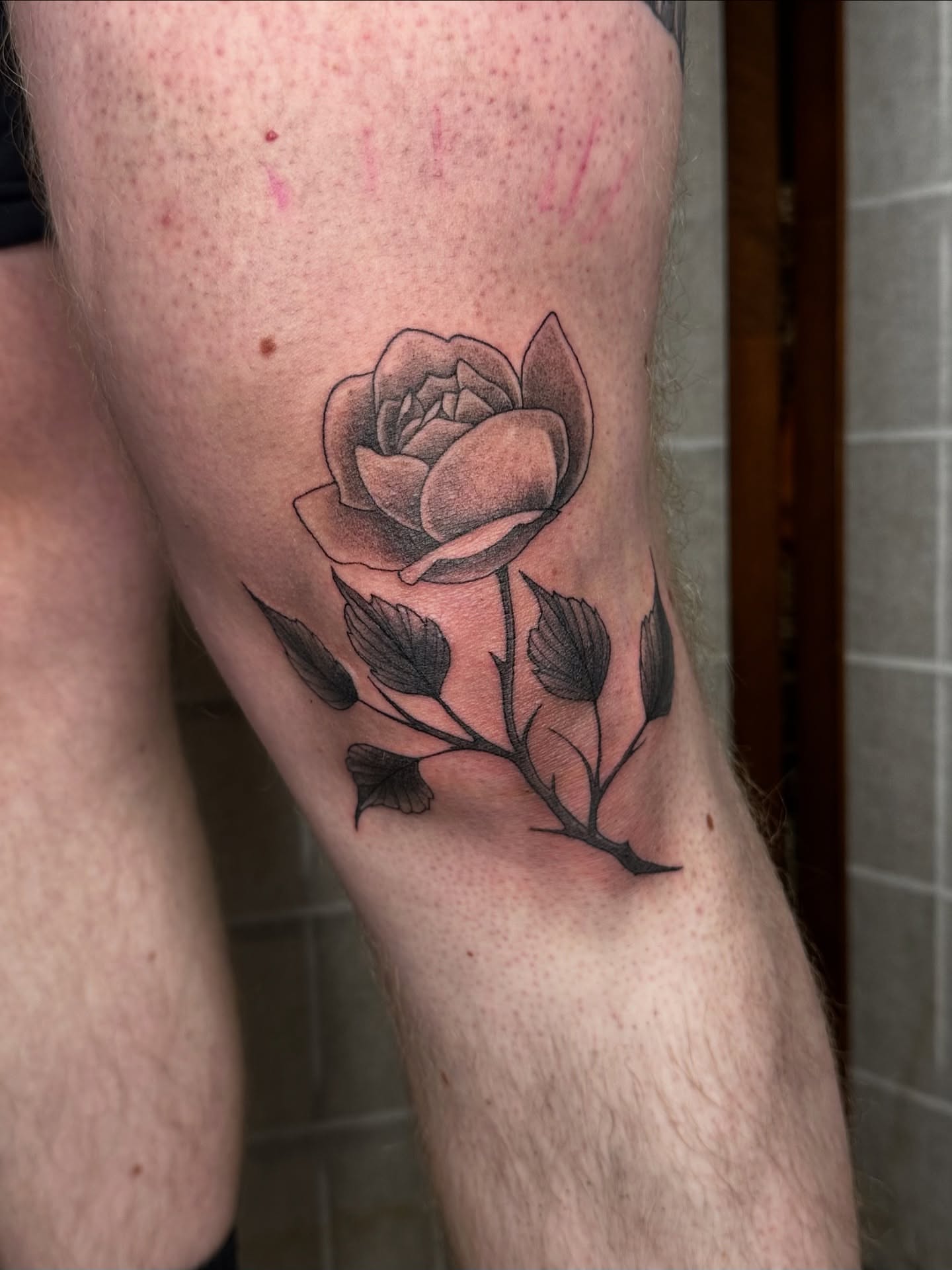 Rose black and grey tattoo on the forearm by Emma Thompson