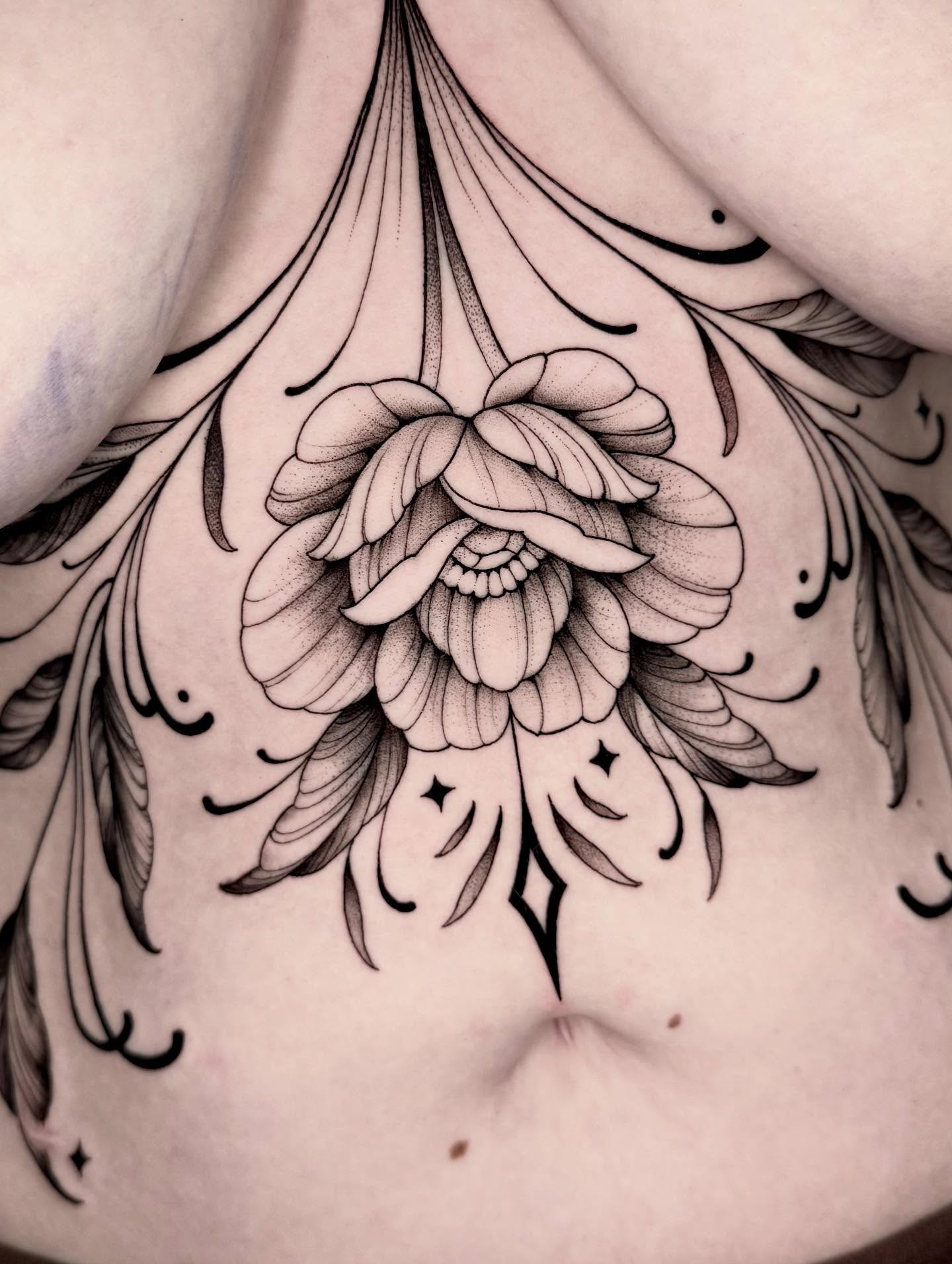 Floral arrangement dotwork tattoo on the chest by Kathryn Semus