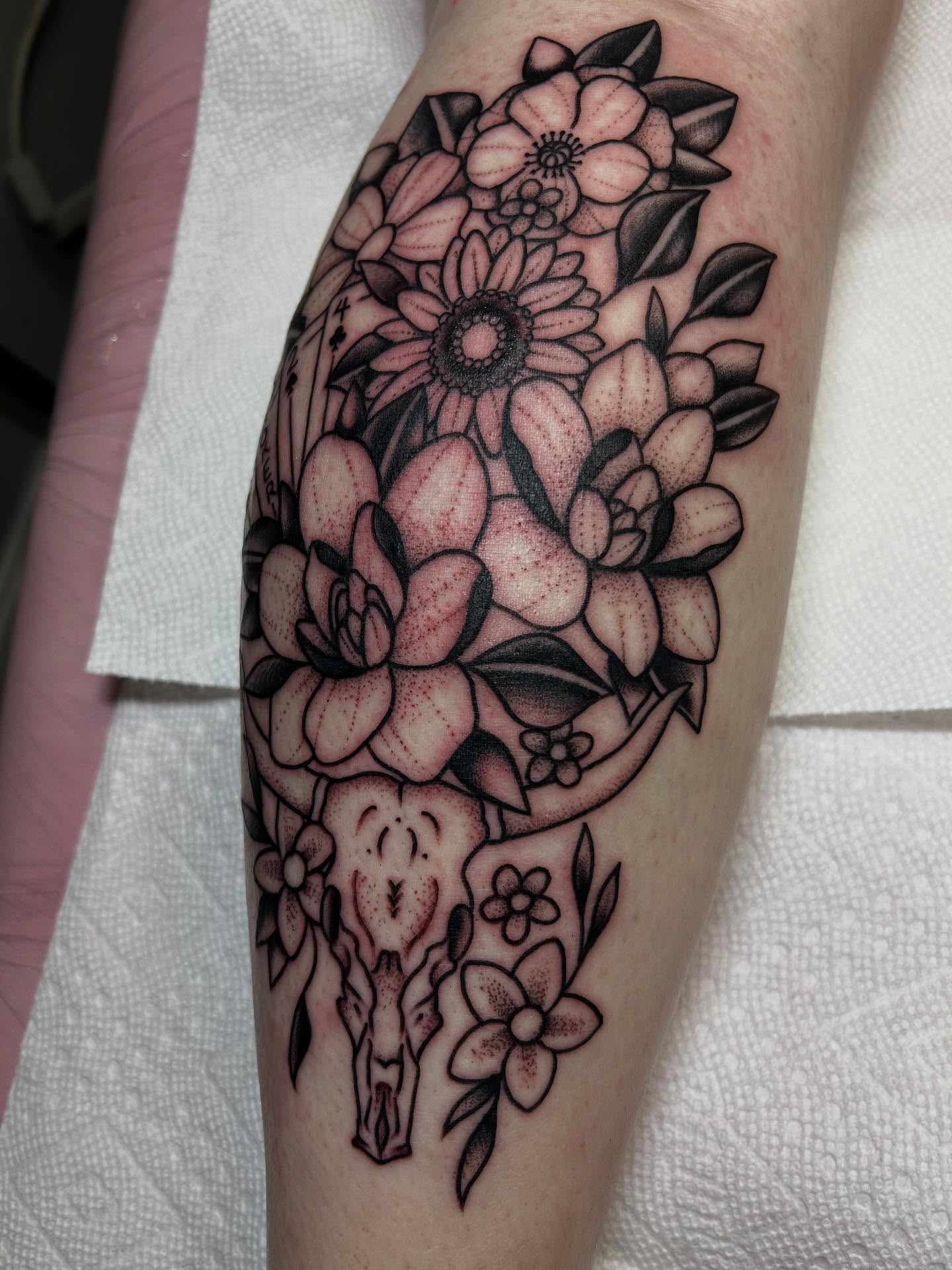 Flower bouquet with skull dotwork tattoo on the forearm by Kelsey Lyons