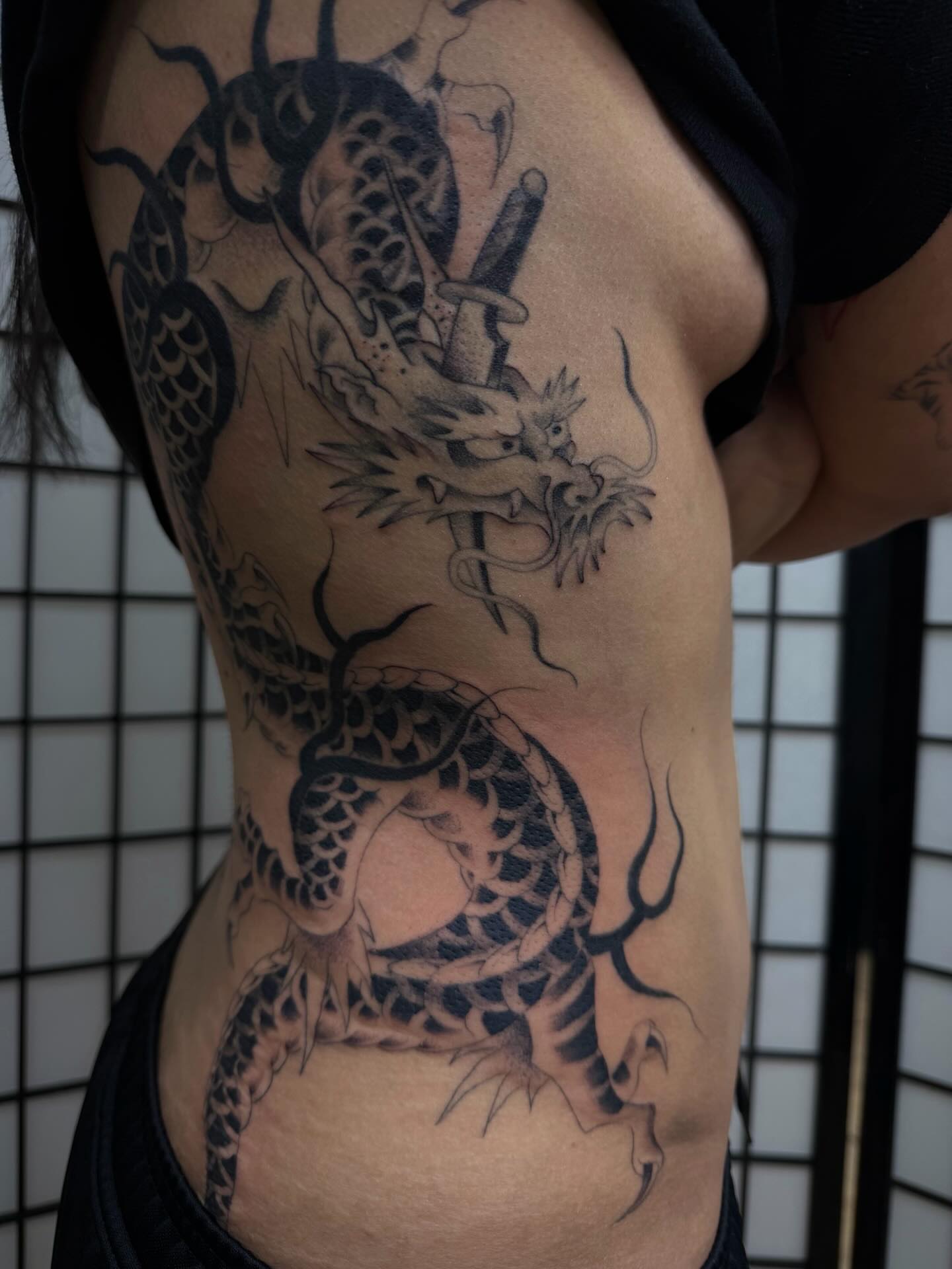 Dragon and sword japanese irezumi tattoo on the ribs by christian martinez