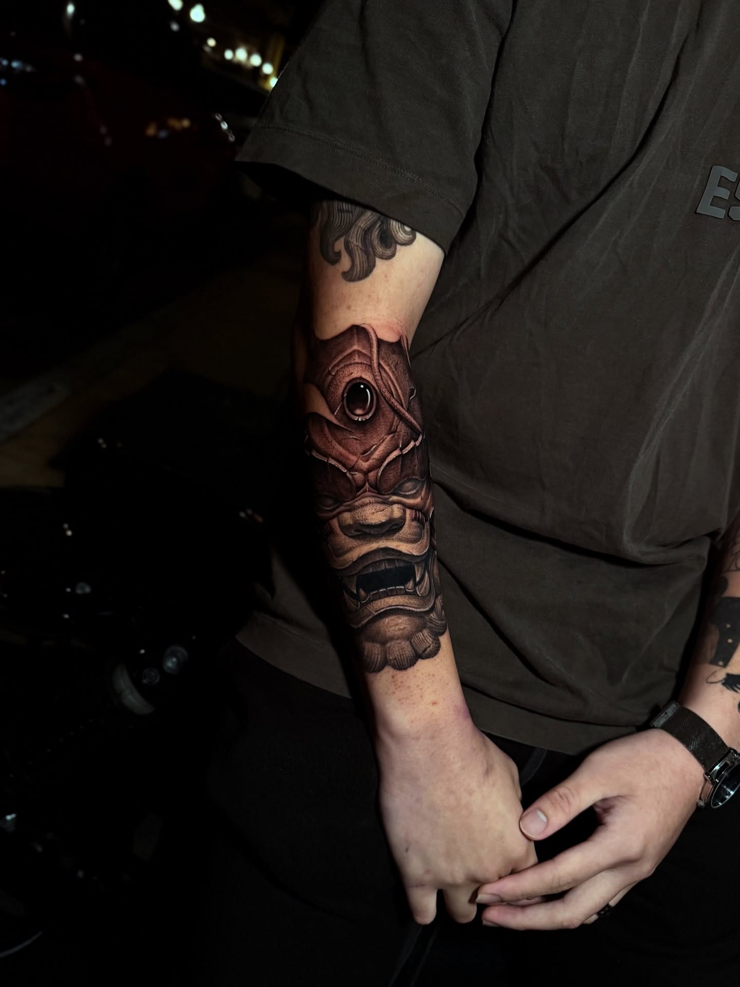Demon mask realism tattoo on the forearm by Anh Nguyen