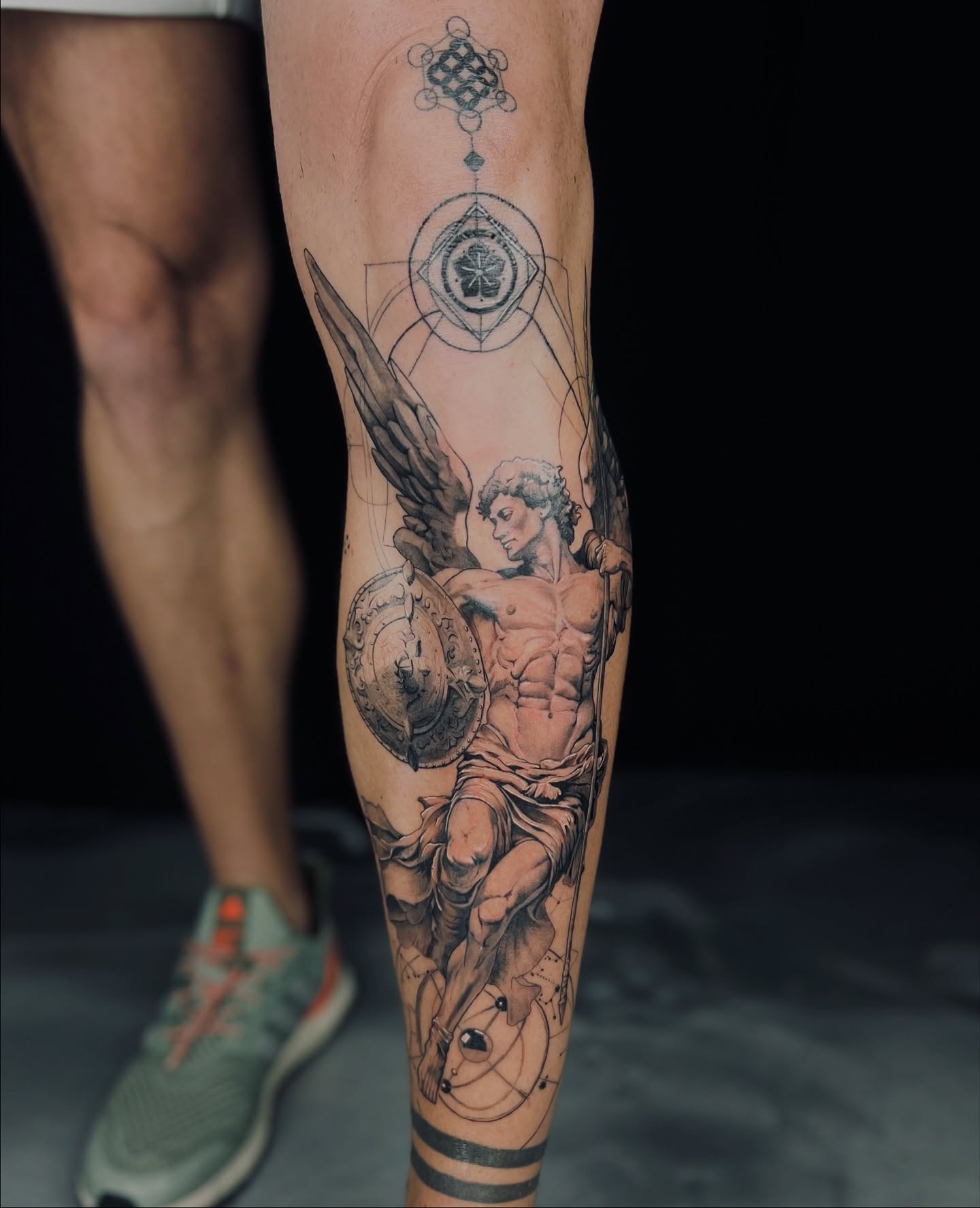 Angel with shield realism tattoo on the calf by Apologies tattoo studios.