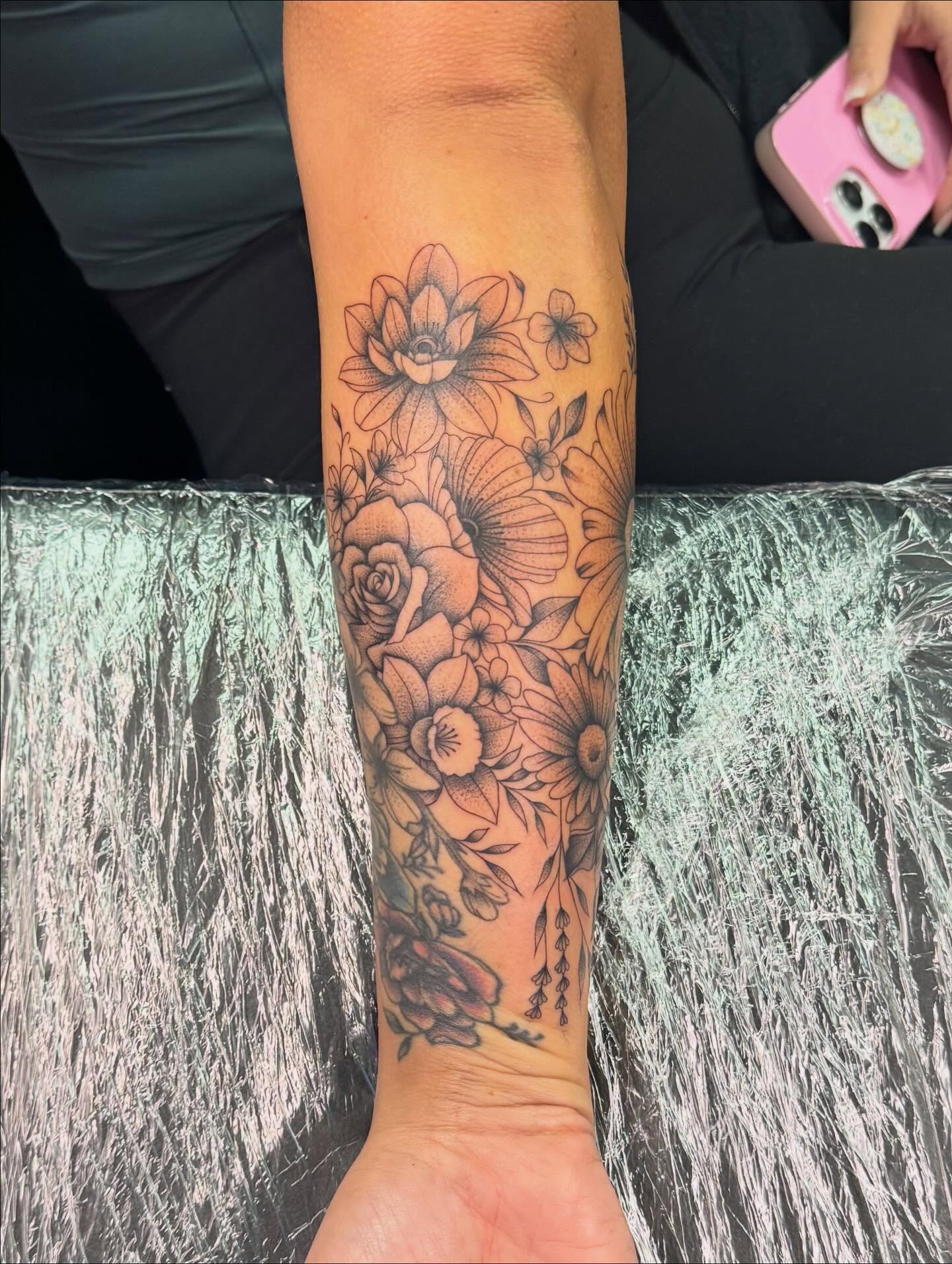 Floral arrangement black and grey tattoo on the forearm by haylie