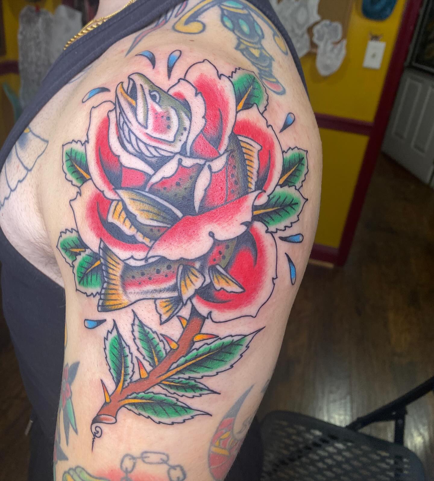 Rose with fish American traditional tattoo on the thigh by Thomas Cook