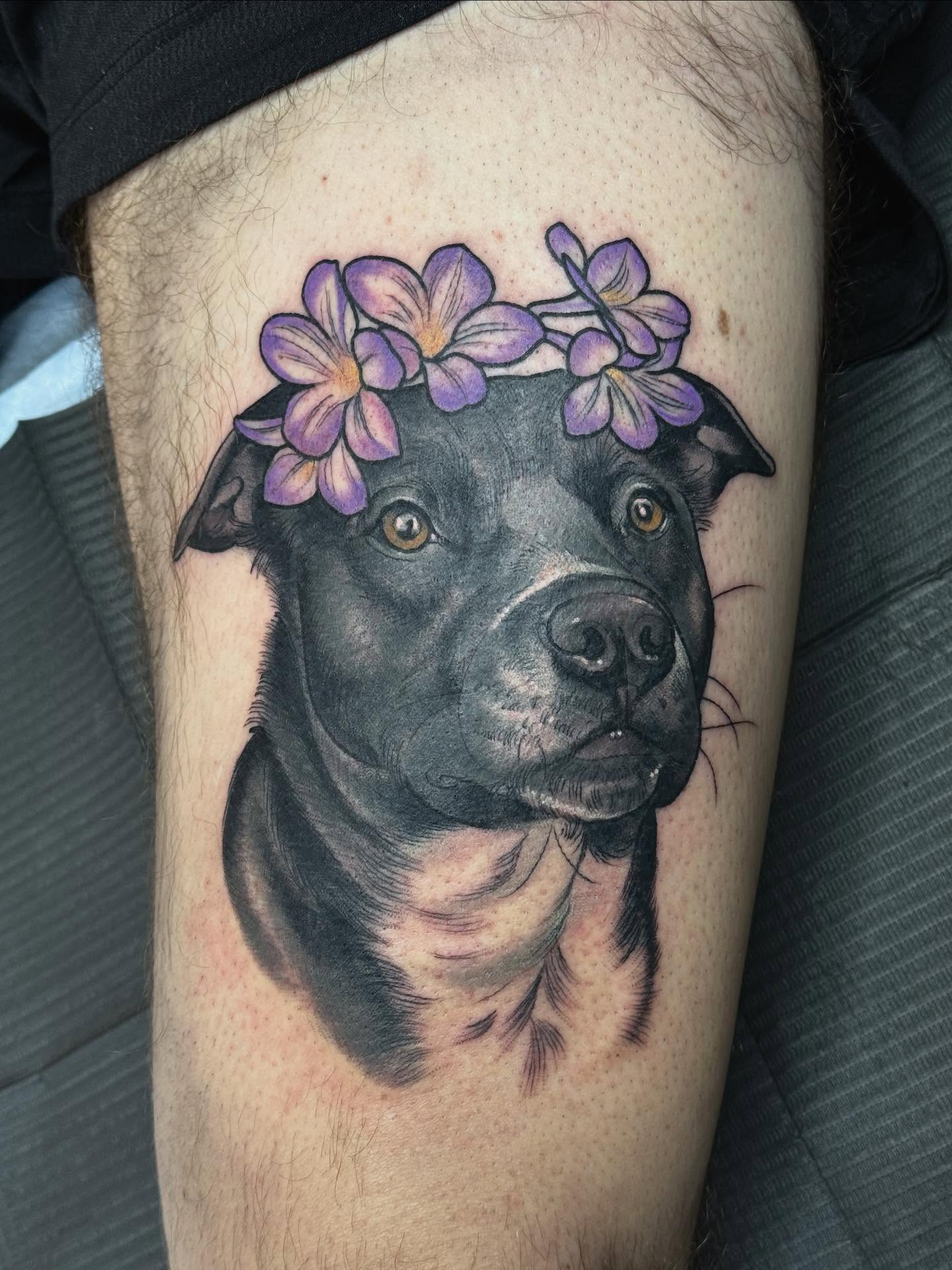 Dog with flowers realism tattoo on the thigh by Rachael Shelly
