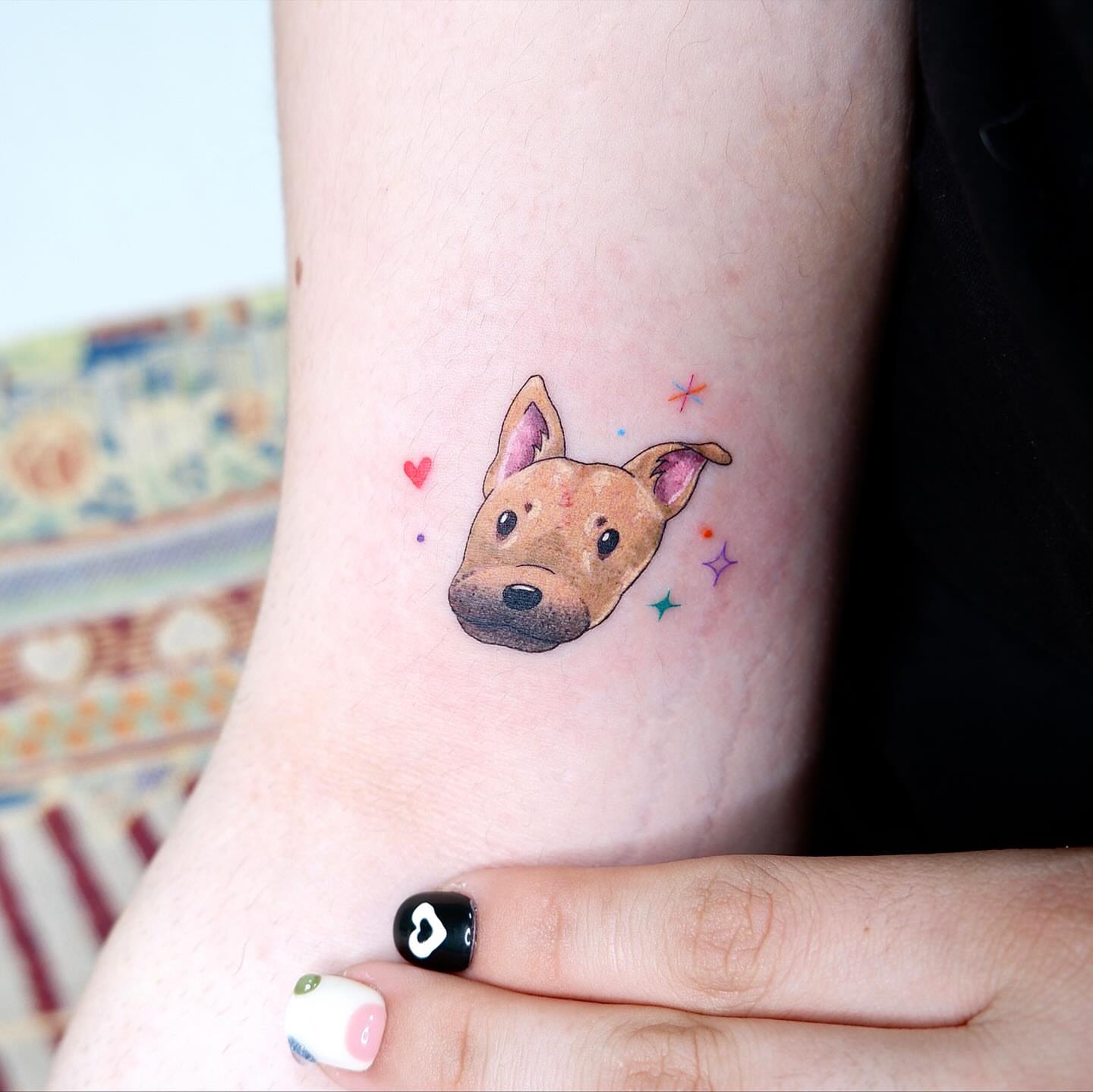 Dog head watercolor tattoo on the forearm by 타투 Seon 컬러타투