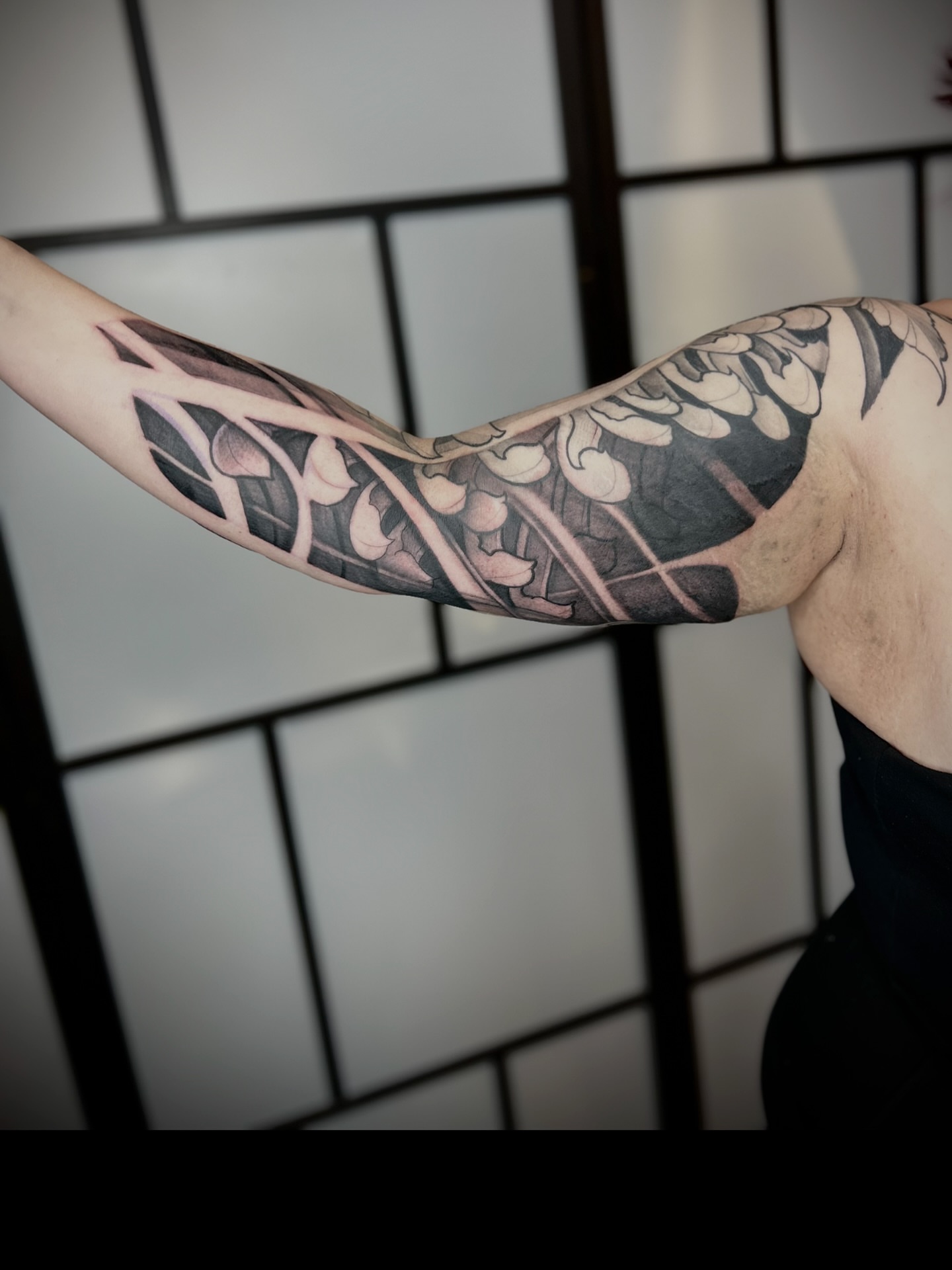 Floral vine black and grey tattoo on the forearm by Ryan Willard, Denver, Colorado