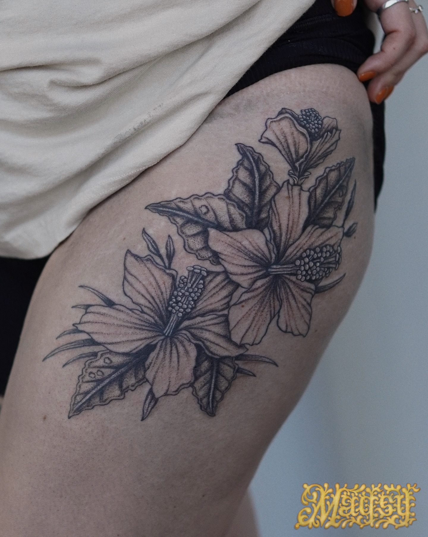 Hibiscus flowers black and grey tattoo on the thigh by Magsy, Orange, California