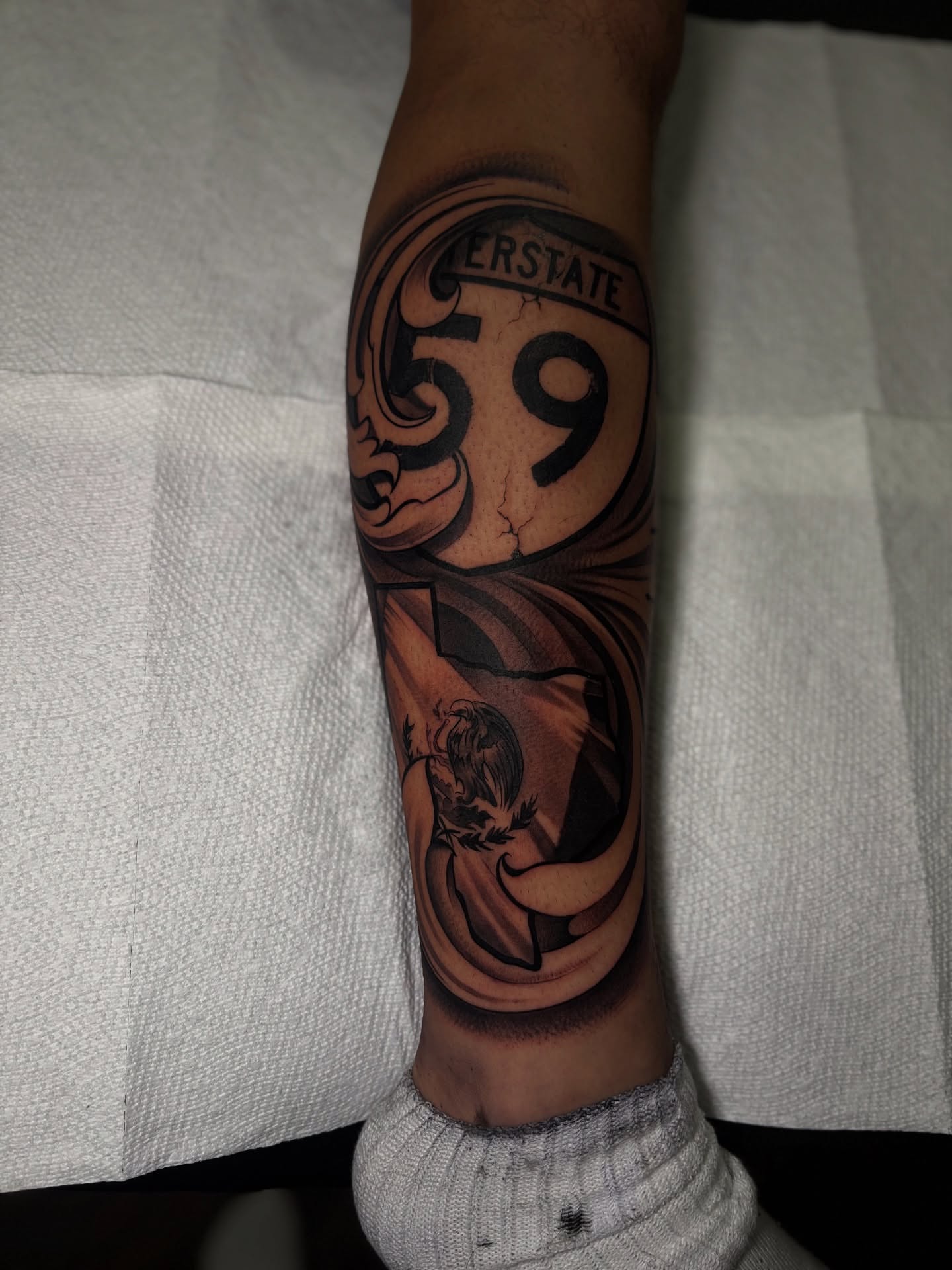 Interstate 59 black and grey tattoo on the forearm by 𝖃𝖆𝖛𝖎𝖊𝖗 𝕬. 𝕾𝖆𝖑𝖎𝖓𝖆𝖘