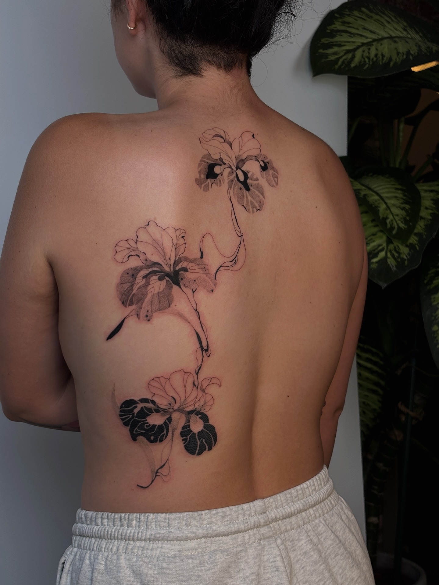 Hibiscus flowers black and grey tattoo on the back by sago, Berkeley, California