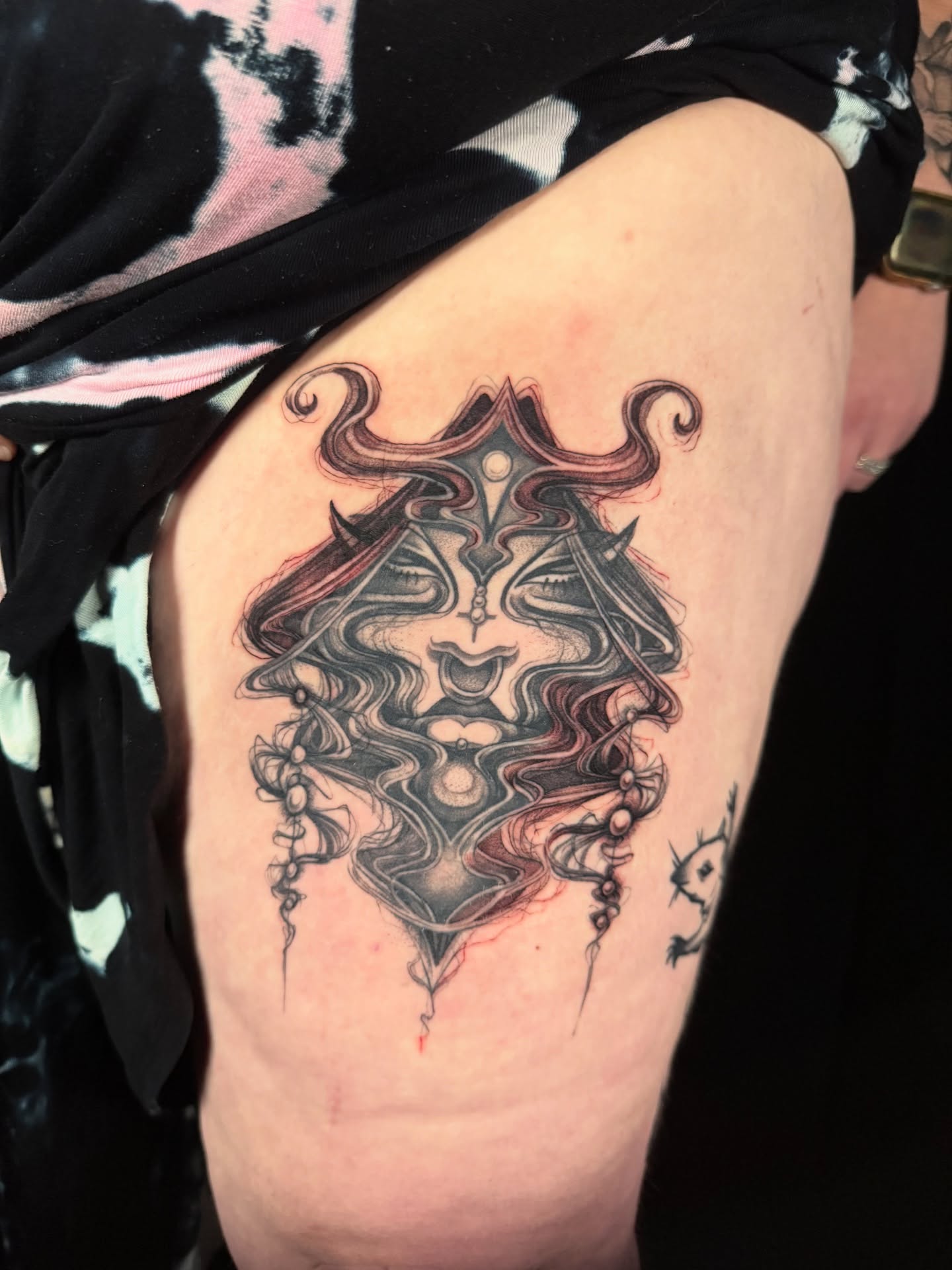 Mask dark realism tattoo on the thigh by z o y a, Seattle, Washington