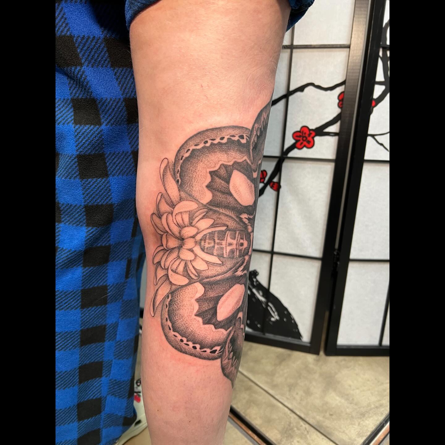 Snake and peony dotwork tattoo on the forearm by Ali, Cedar Rapids, Iowa