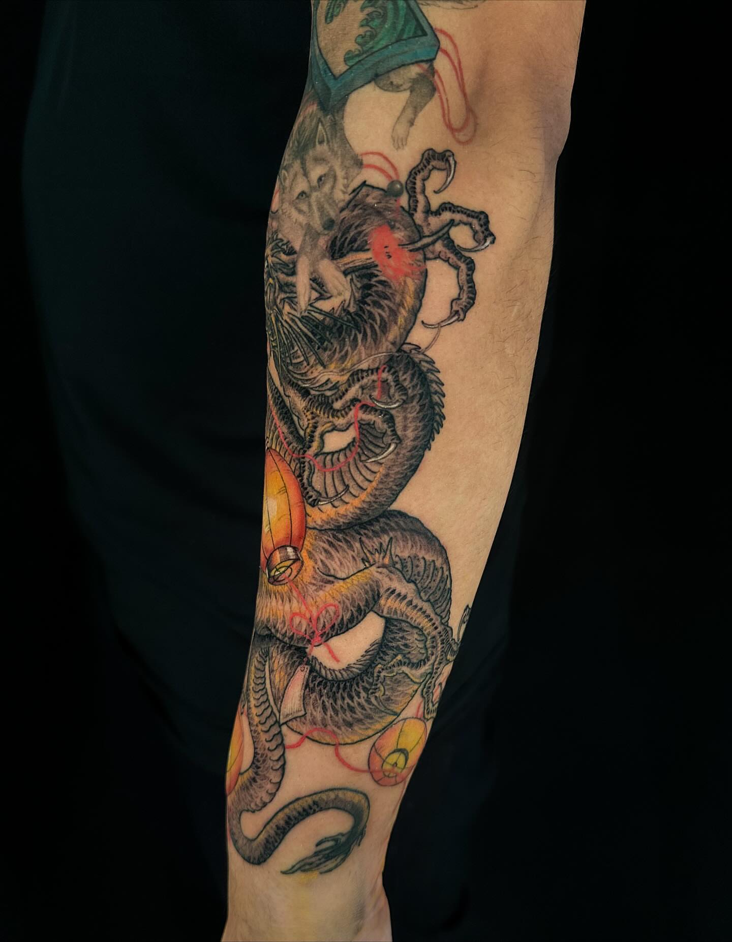 Dragon and wolf japanese irezumi tattoo on the forearm by Vince Lau