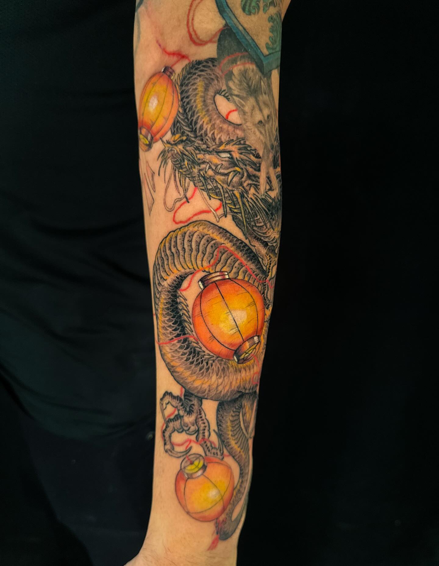 Dragon and lanterns American traditional tattoo on the forearm by Vince Lau