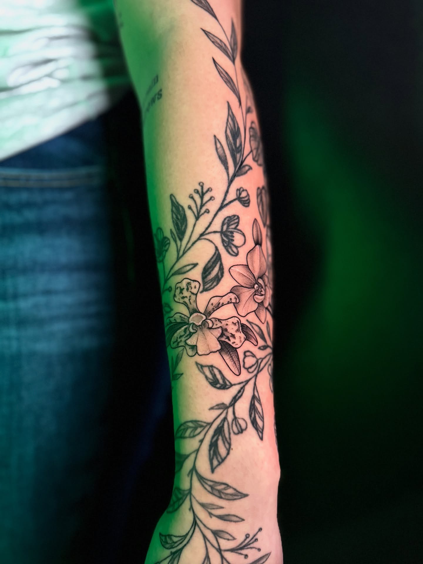 Floral arrangement black and grey tattoo on the forearm by Lily Bejarno