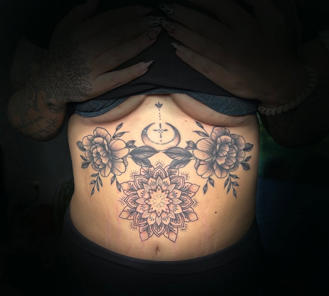 Mandala with flowers and moon geometric tattoo on the torso by Kiersten Tickle
