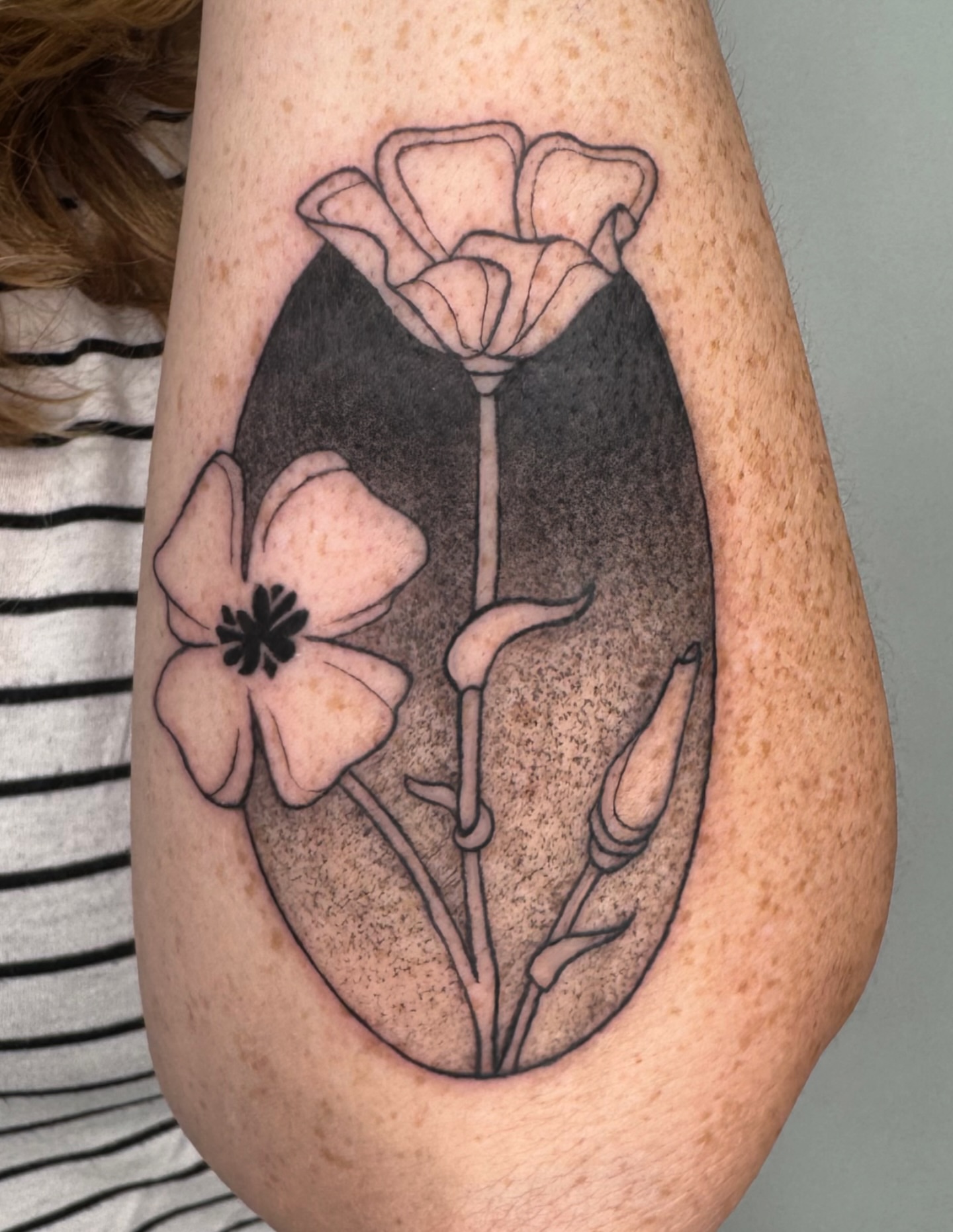 Flowers black and grey tattoo on the forearm by Tiffany