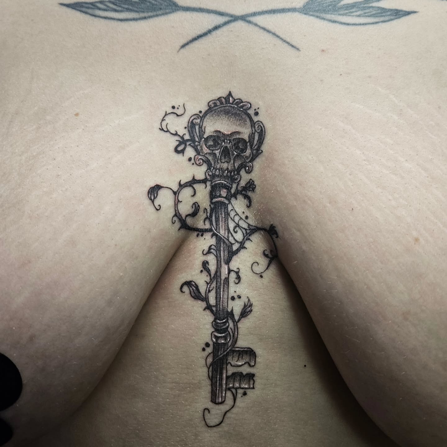 Key with skull ornamental tattoo on the thigh by Ari🖤