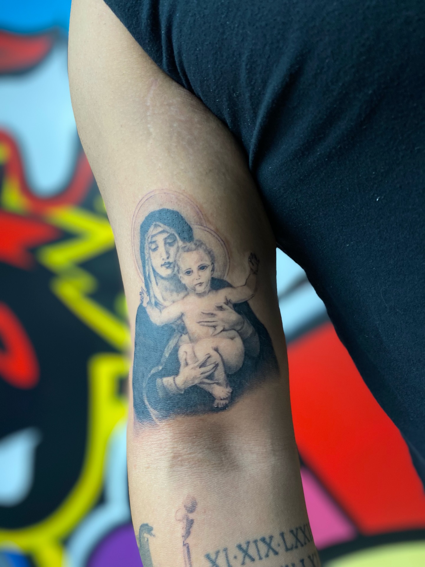 Religious iconography black and grey tattoo on the forearm by Antonio